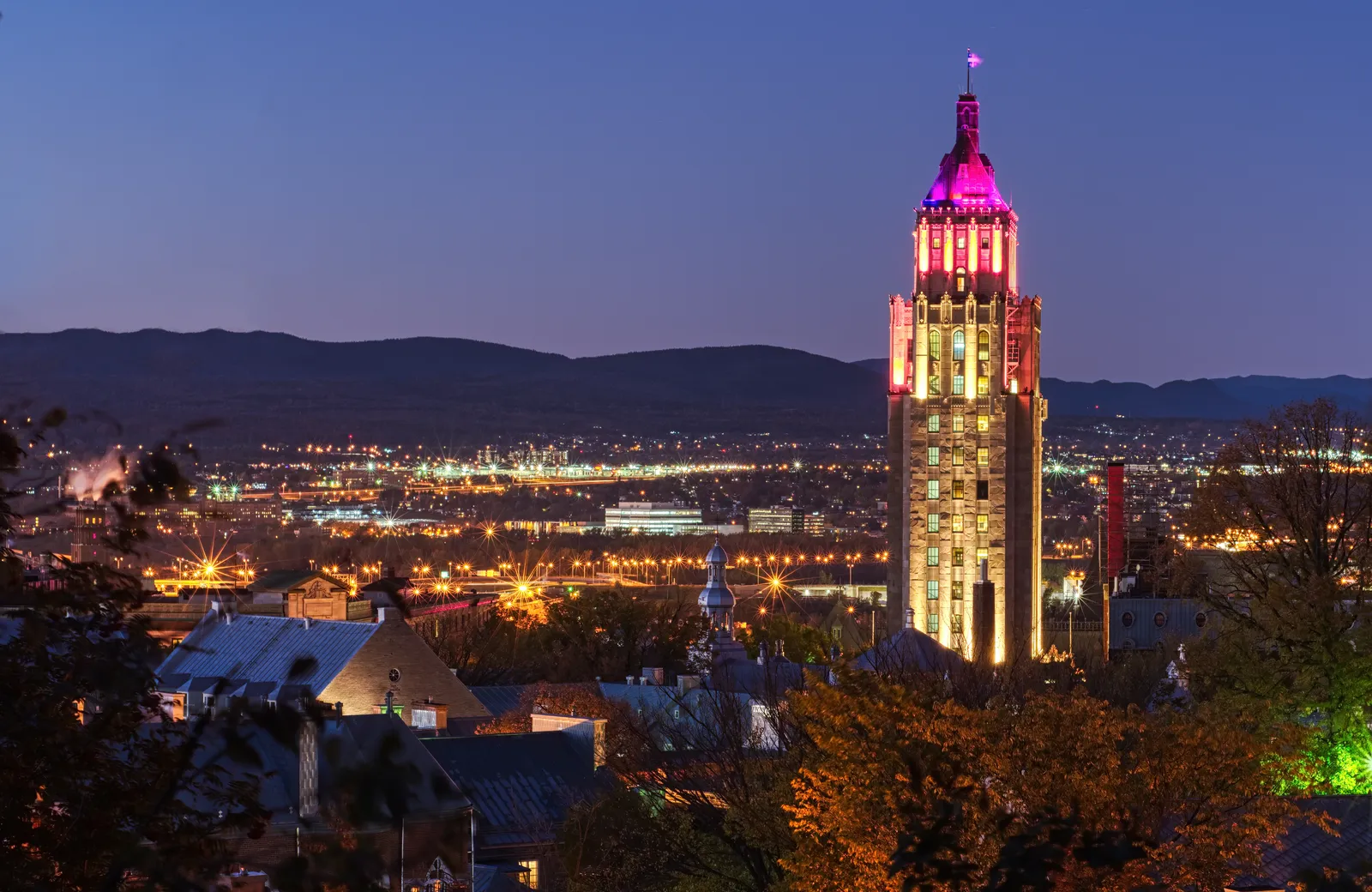 A city skyline lit up at dusk