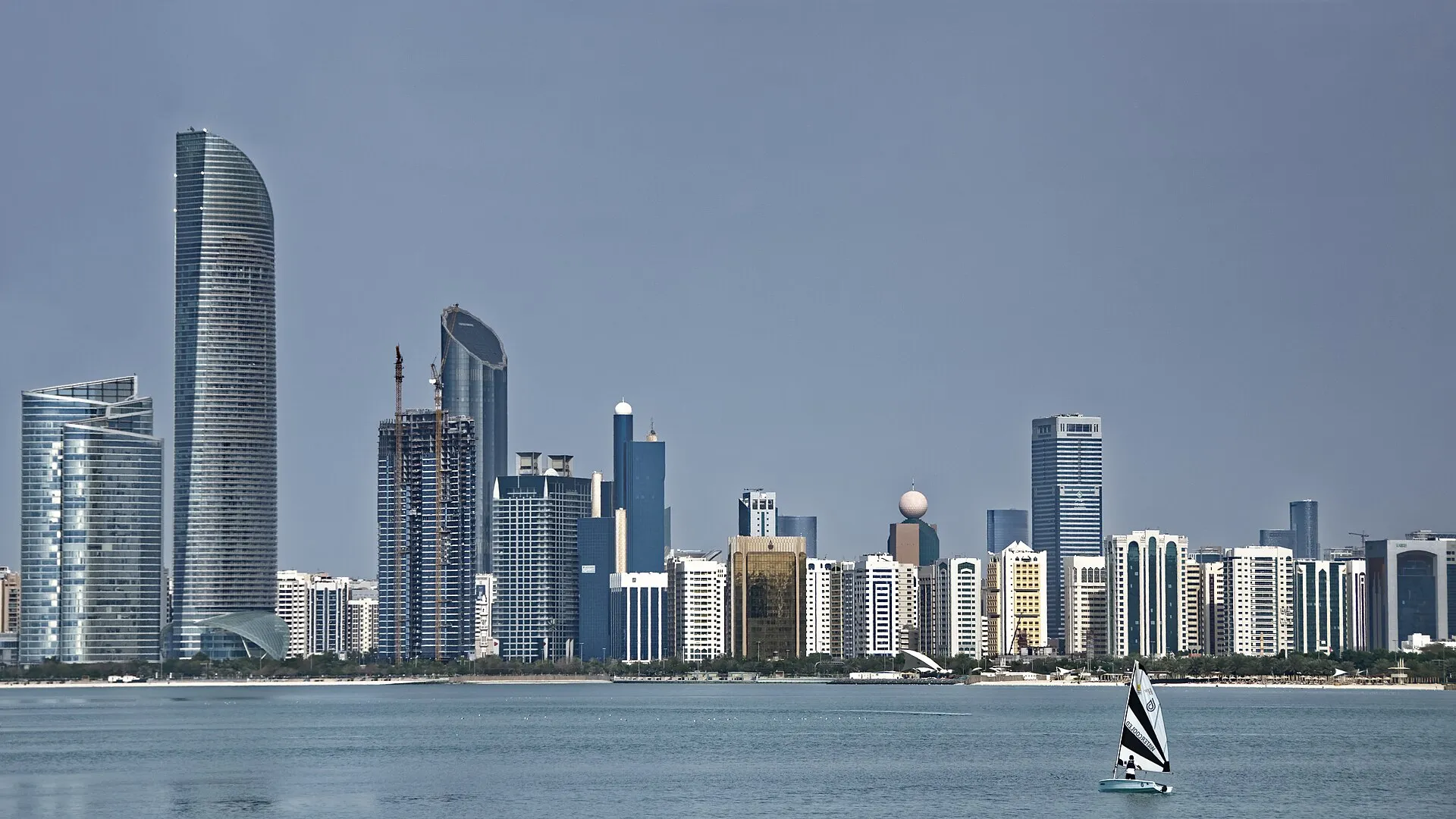Abu Dhabi skyline viewed from the water, with the curved ADIA tower and Corniche skyscrapers