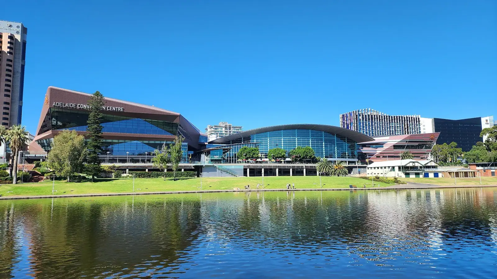Adelaide Convention Centre and River Torrens under a bright blue sky