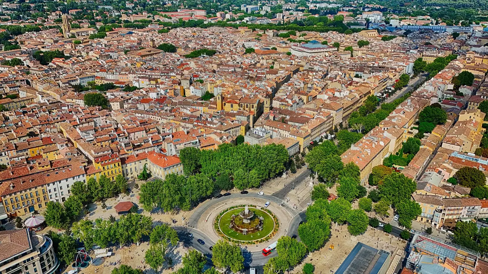 Aerial view of Aix-en-Provence with the Fontaine de la Rotonde and the tree-lined Cours Mirabeau leading into the terracotta-roofed old town