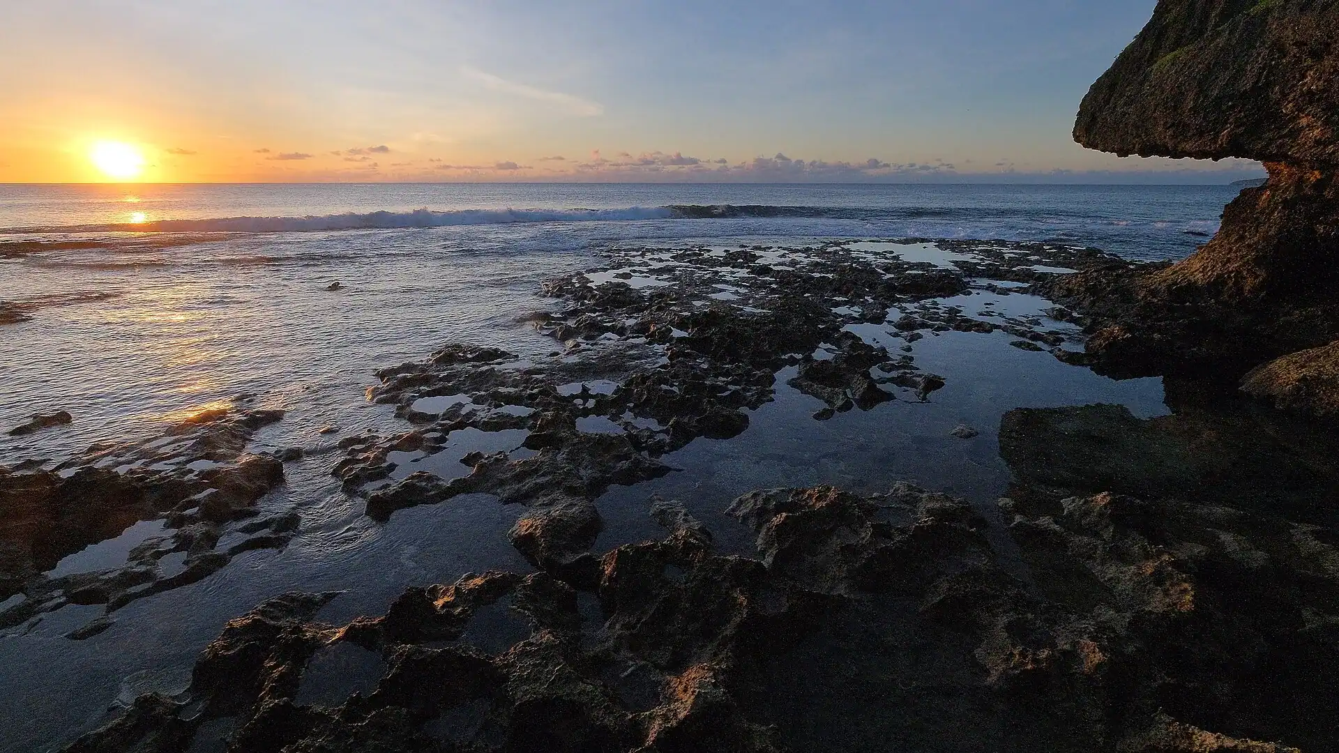 Sunset over the reef flat on the coast at Alofi