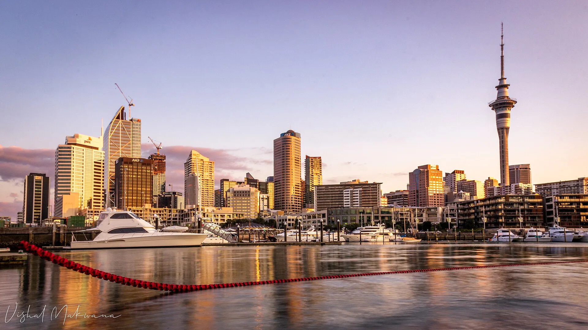 Auckland skyline and Sky Tower at golden hour, viewed from Wynyard Quarter marina