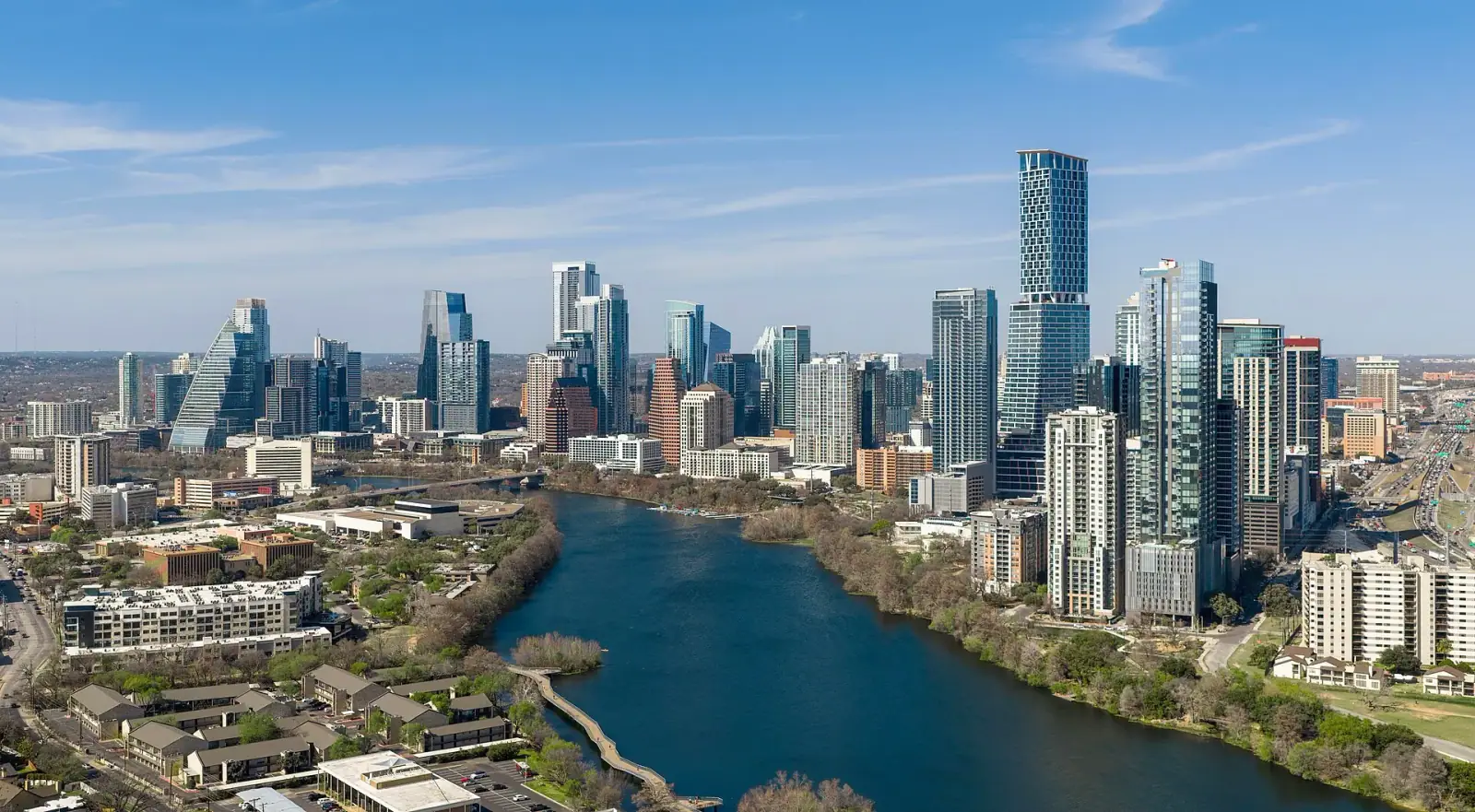 Aerial daytime view of Austin, Texas skyline with Lady Bird Lake in the foreground