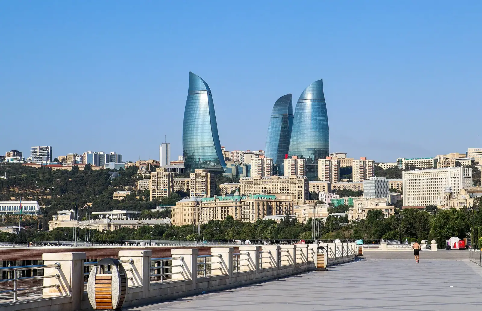 Baku Boulevard promenade with the Flame Towers rising above the city skyline