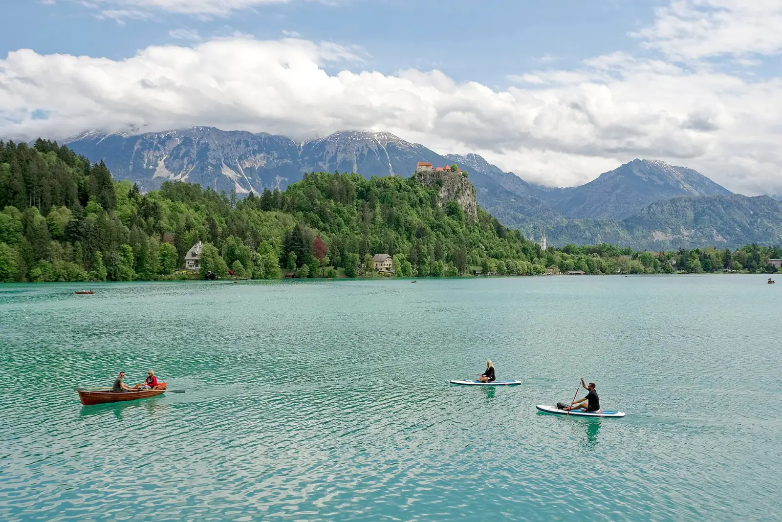 Turquoise Lake Bled with Bled Castle on the cliff and Julian Alps, Slovenia