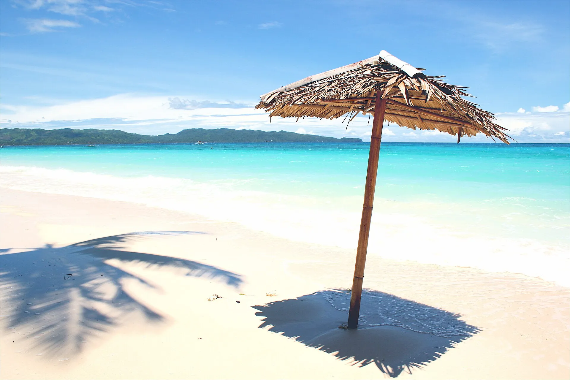 Boracay White Beach daytime, powdery white sand with turquoise sea and bamboo parasol