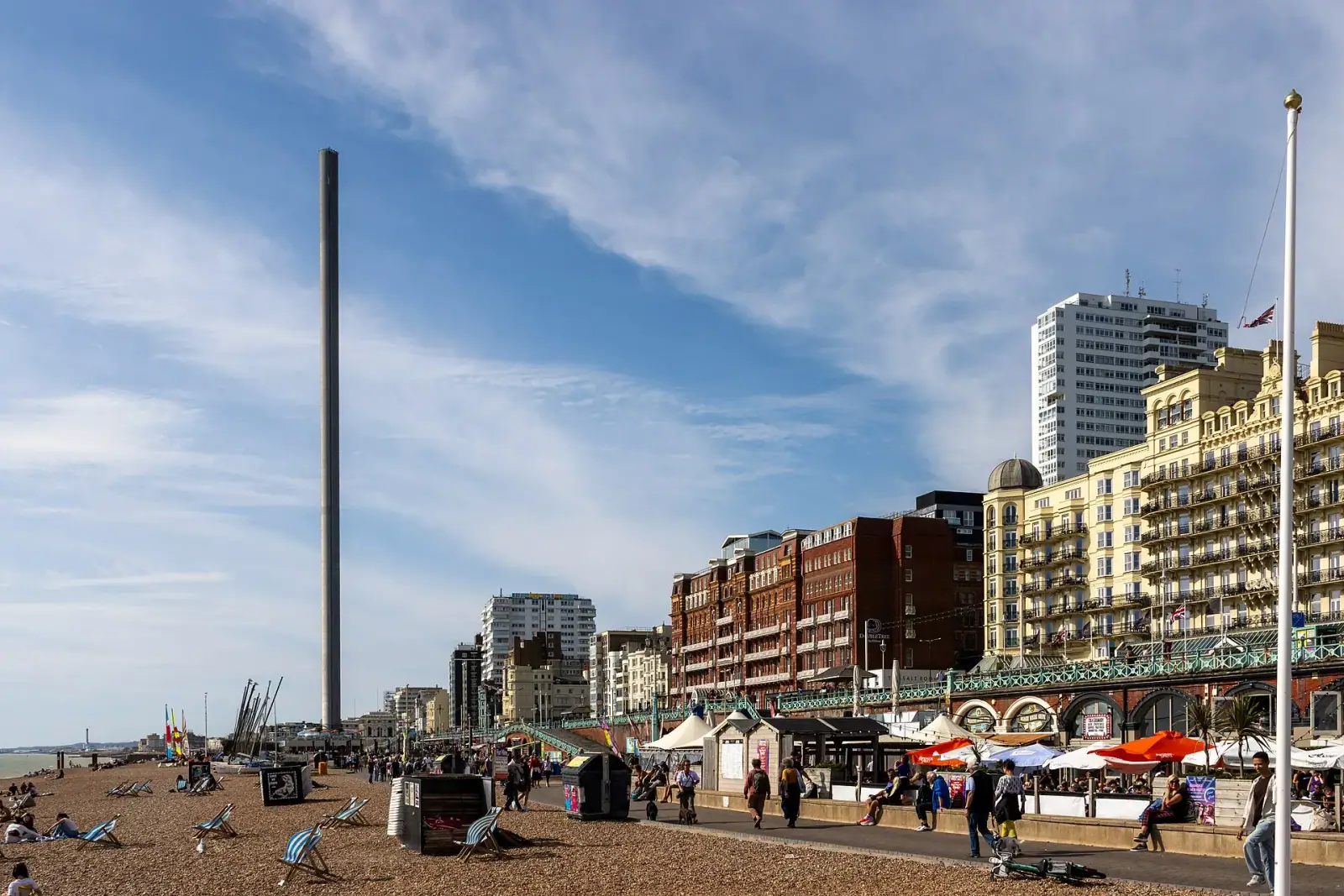 Brighton seafront with the British Airways i360 tower, pebble beach, and Victorian buildings