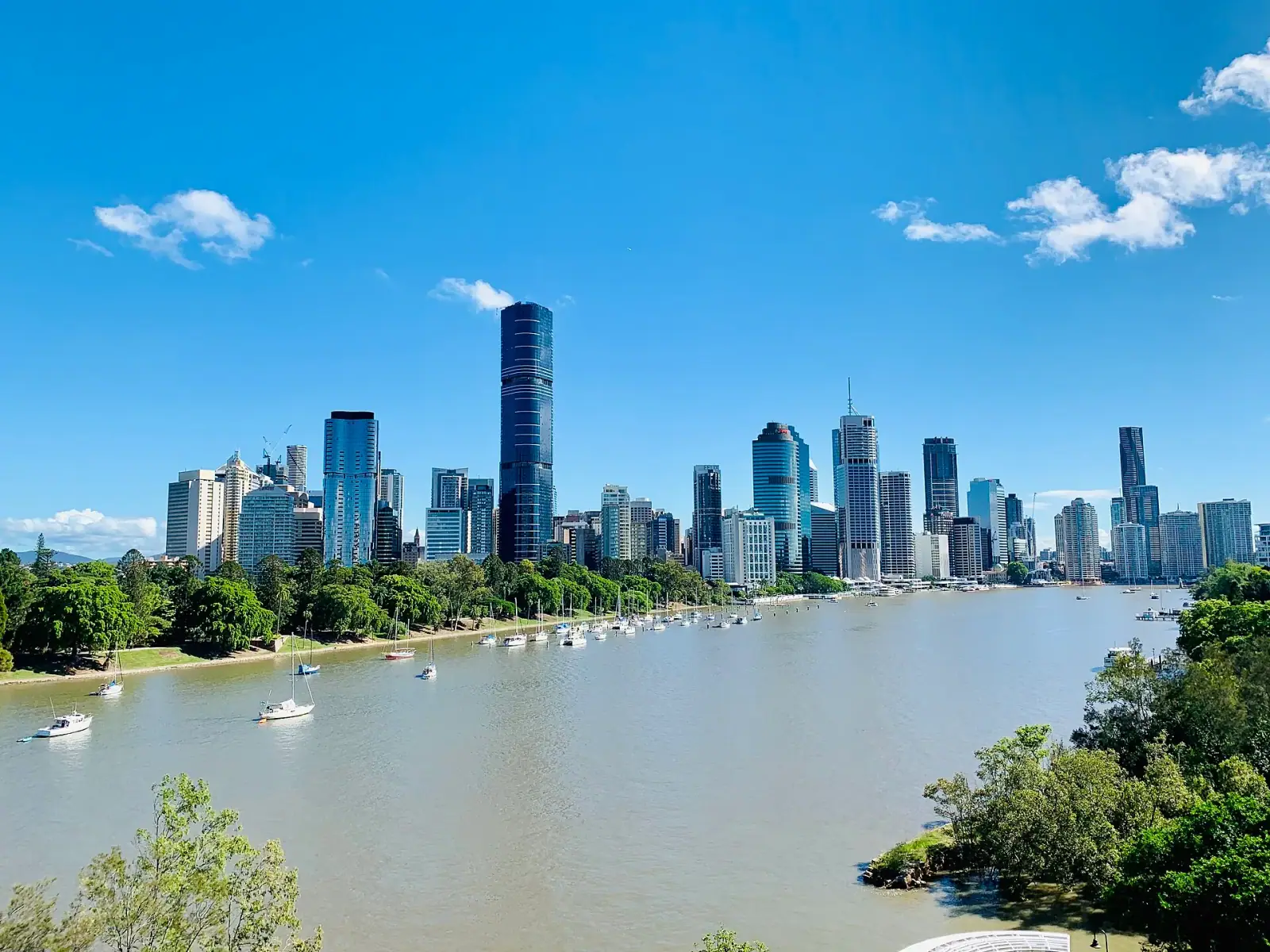 Brisbane CBD skyline seen from Kangaroo Point with the Brisbane River and sailboats in the foreground