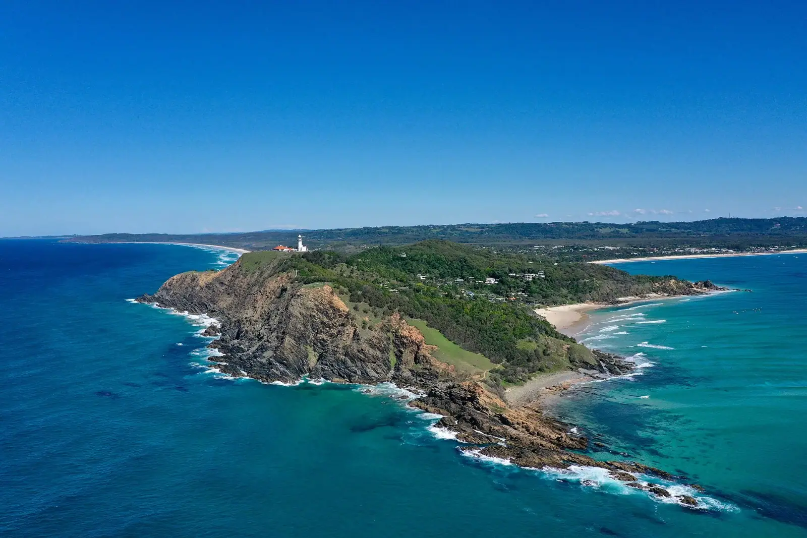 Aerial view of Cape Byron headland with lighthouse, beaches, and turquoise ocean, Byron Bay, Australia