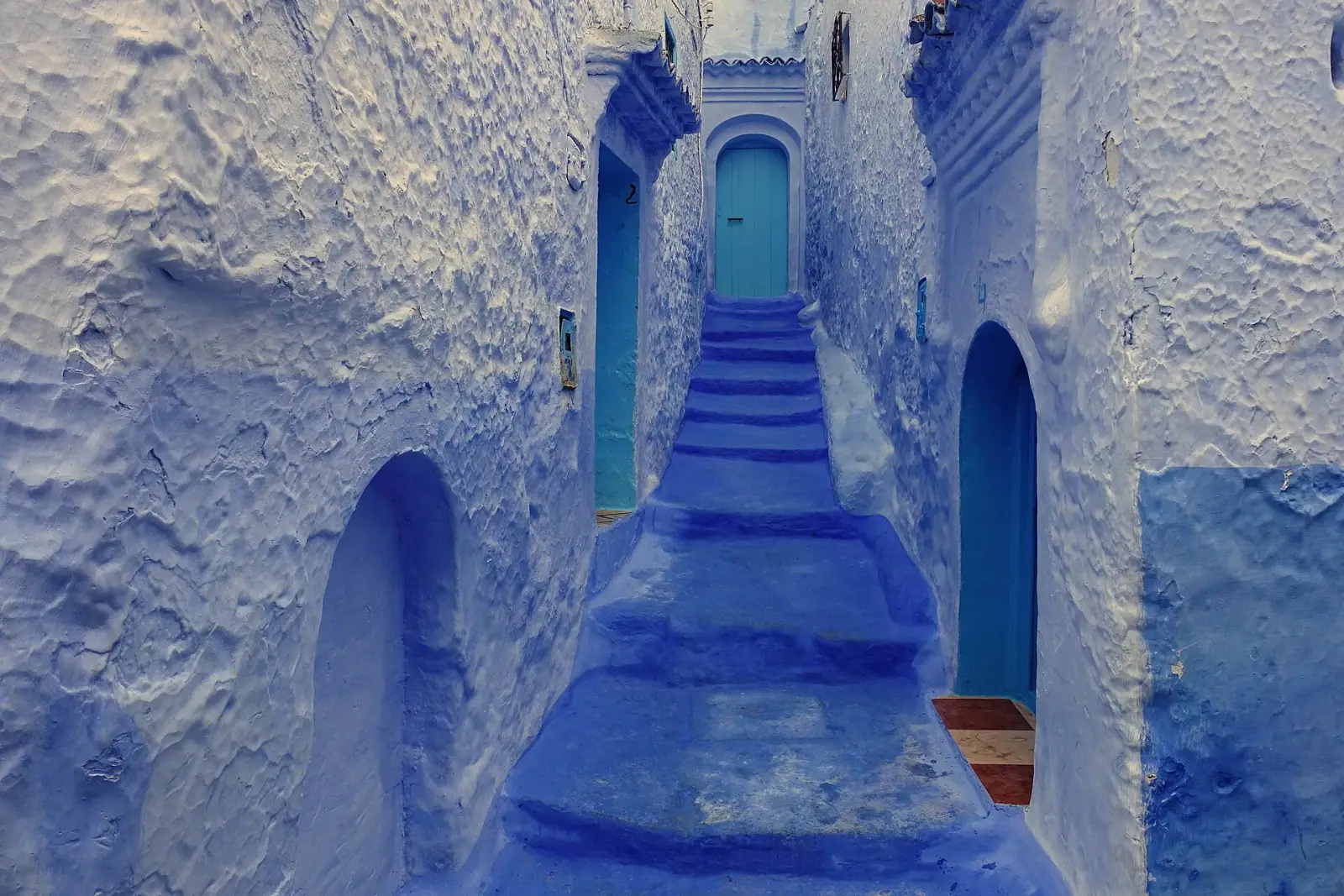 Blue-painted staircase alley in Chefchaouen medina, Morocco