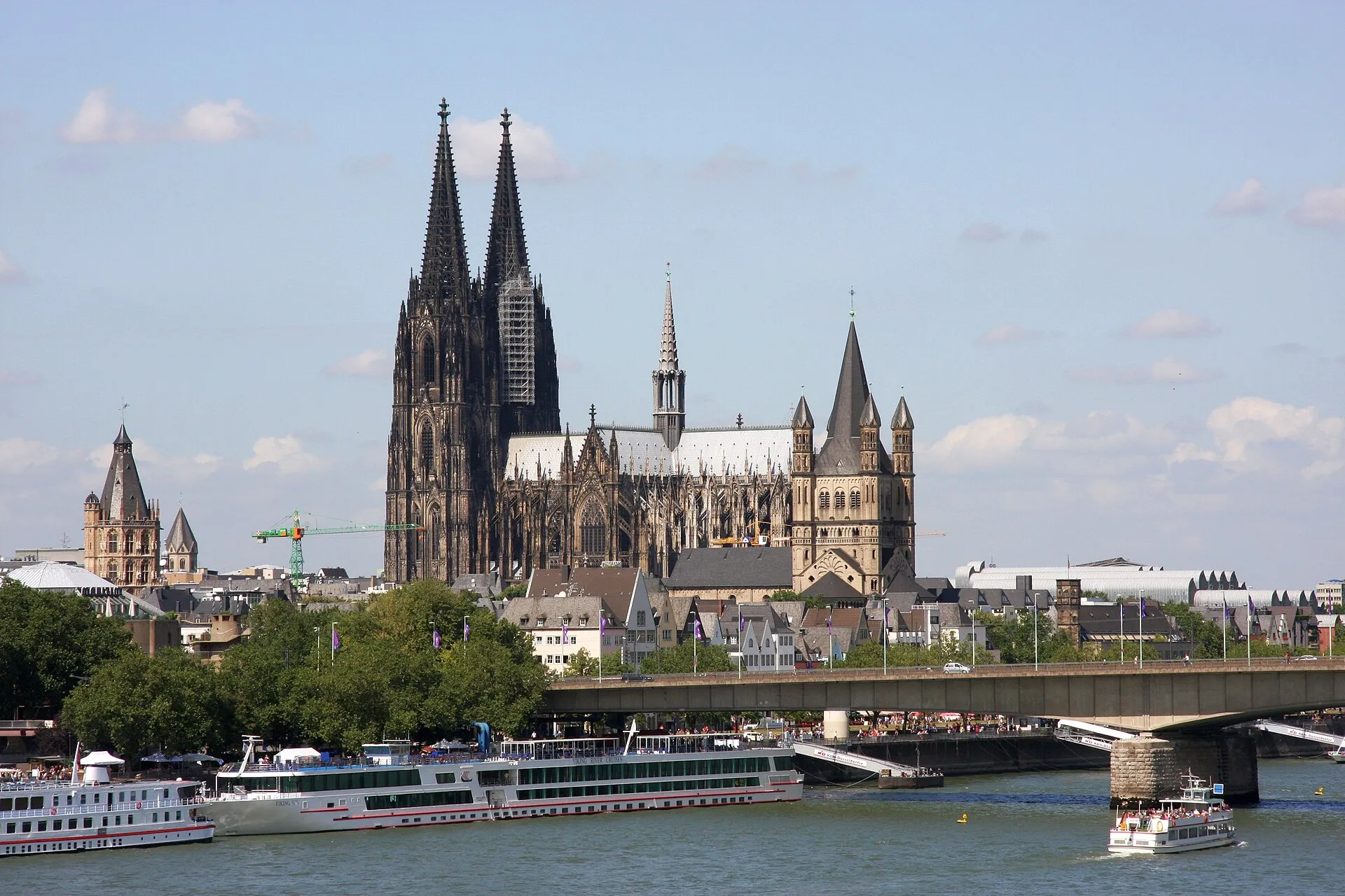 Cologne Cathedral and Great St. Martin Church seen from across the Rhine on a sunny day