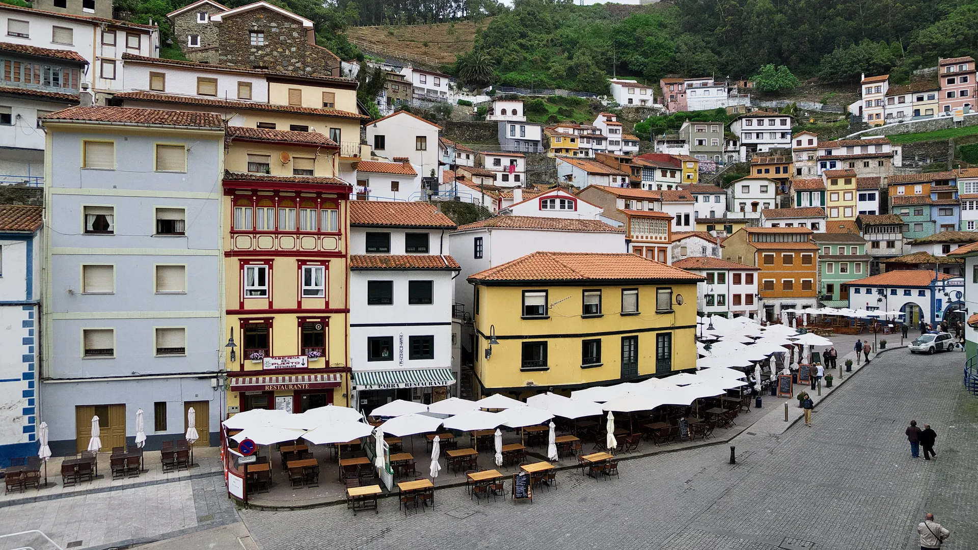 Colorful houses climbing the cliff amphitheatre above the harbour of Cudillero, Spain
