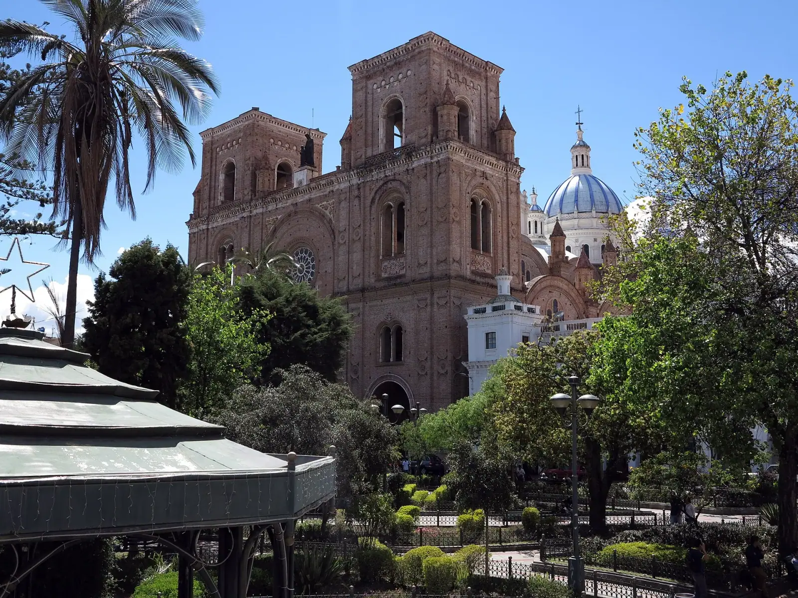New Cathedral of Cuenca rising above Parque Calderon with its iconic blue dome against a blue sky
