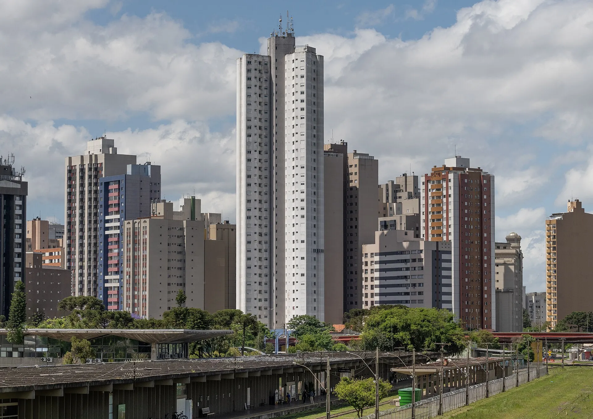 Curitiba skyline of residential towers with a transit station and green space in the foreground