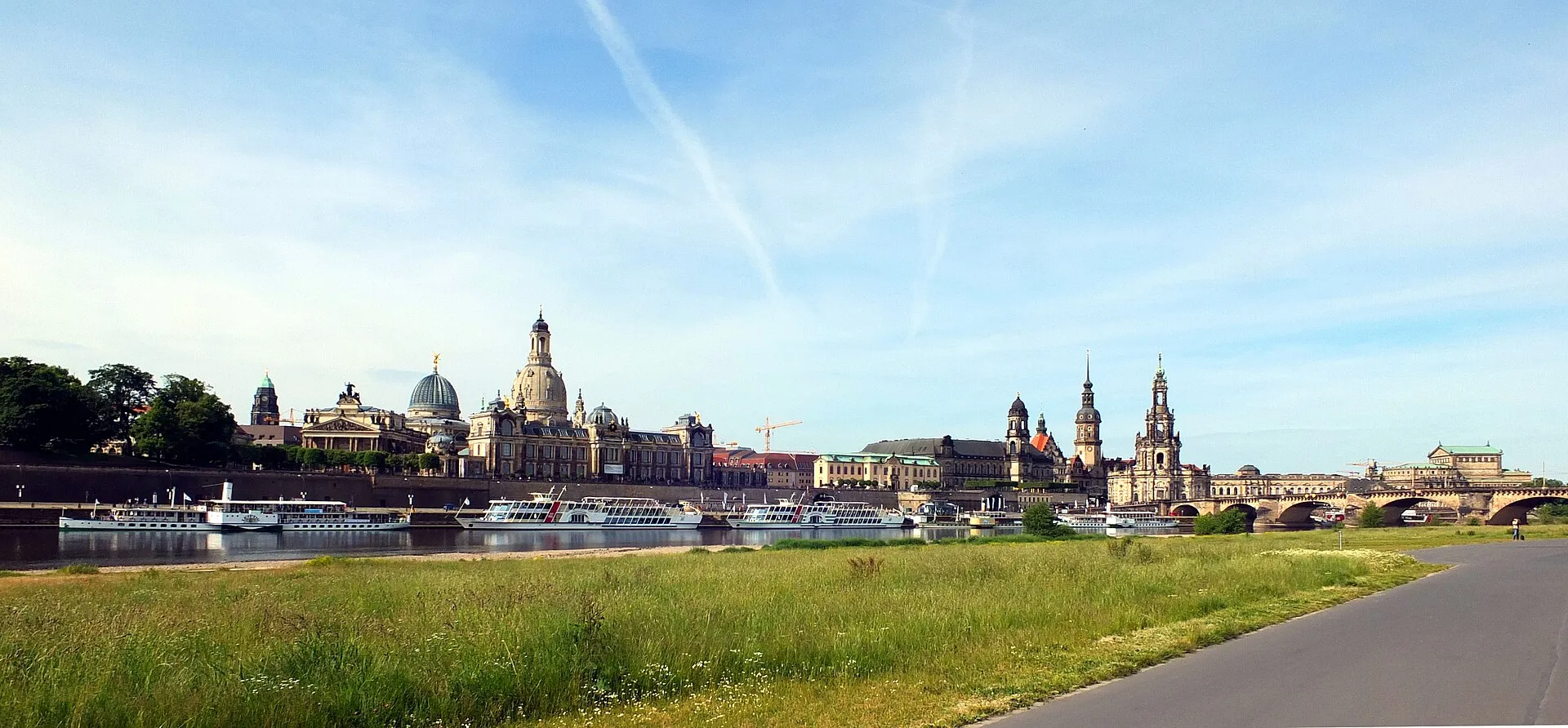 Dresden skyline seen from across the Elbe river, with the Frauenkirche dome and Hofkirche tower rising above the Baroque cityscape