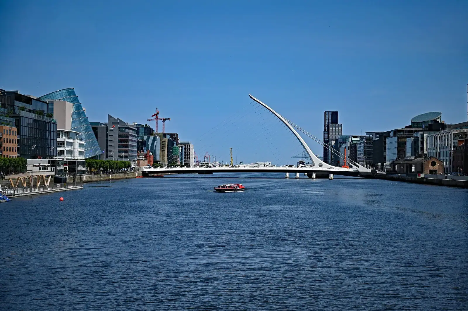 Samuel Beckett Bridge spanning the River Liffey with Dublin Docklands skyline