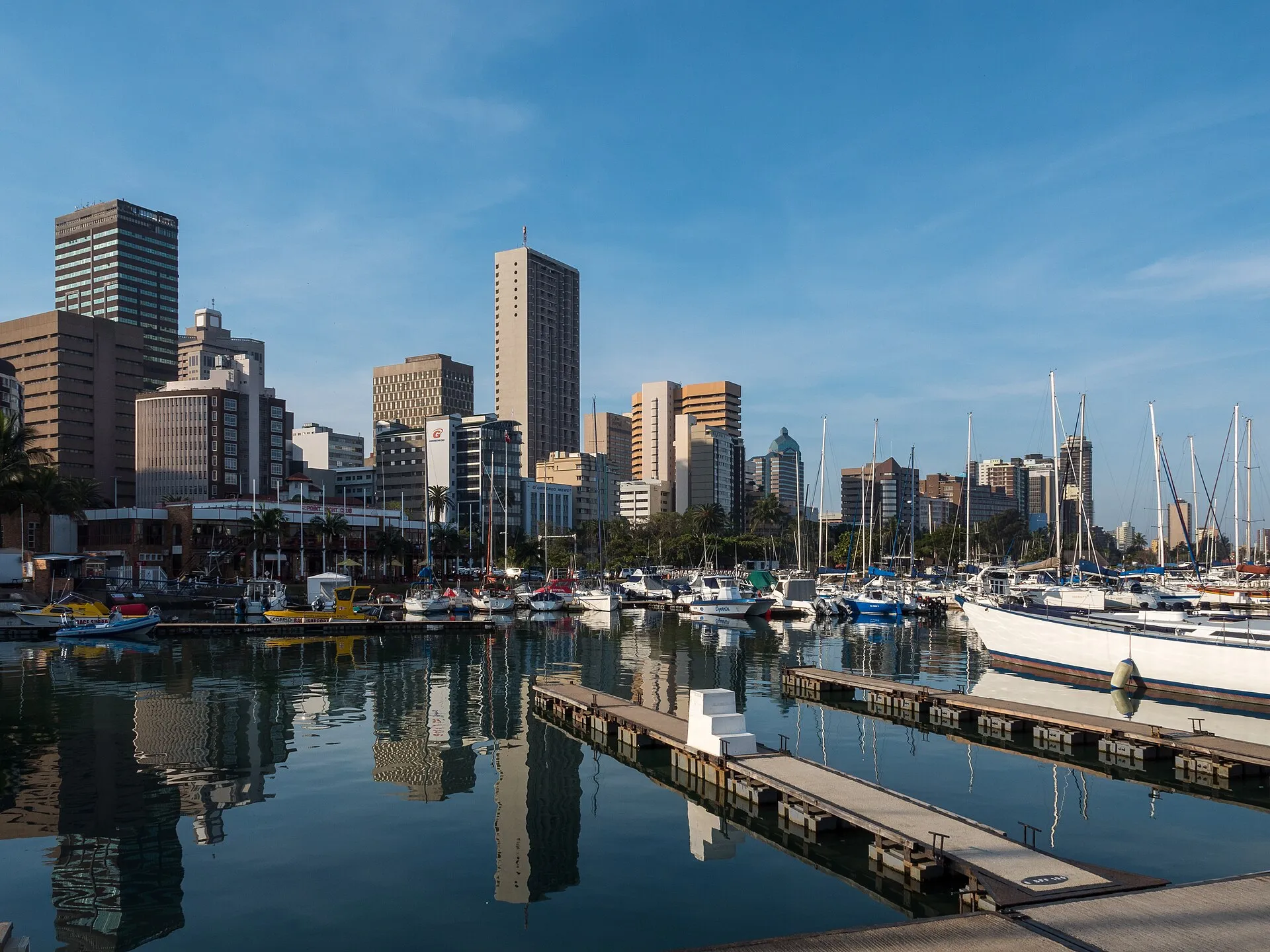 Yachts in Durban harbour with the city skyline behind