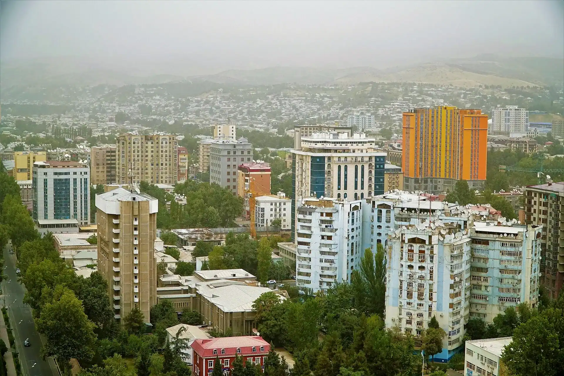 Dushanbe below the hills, with its newer towers