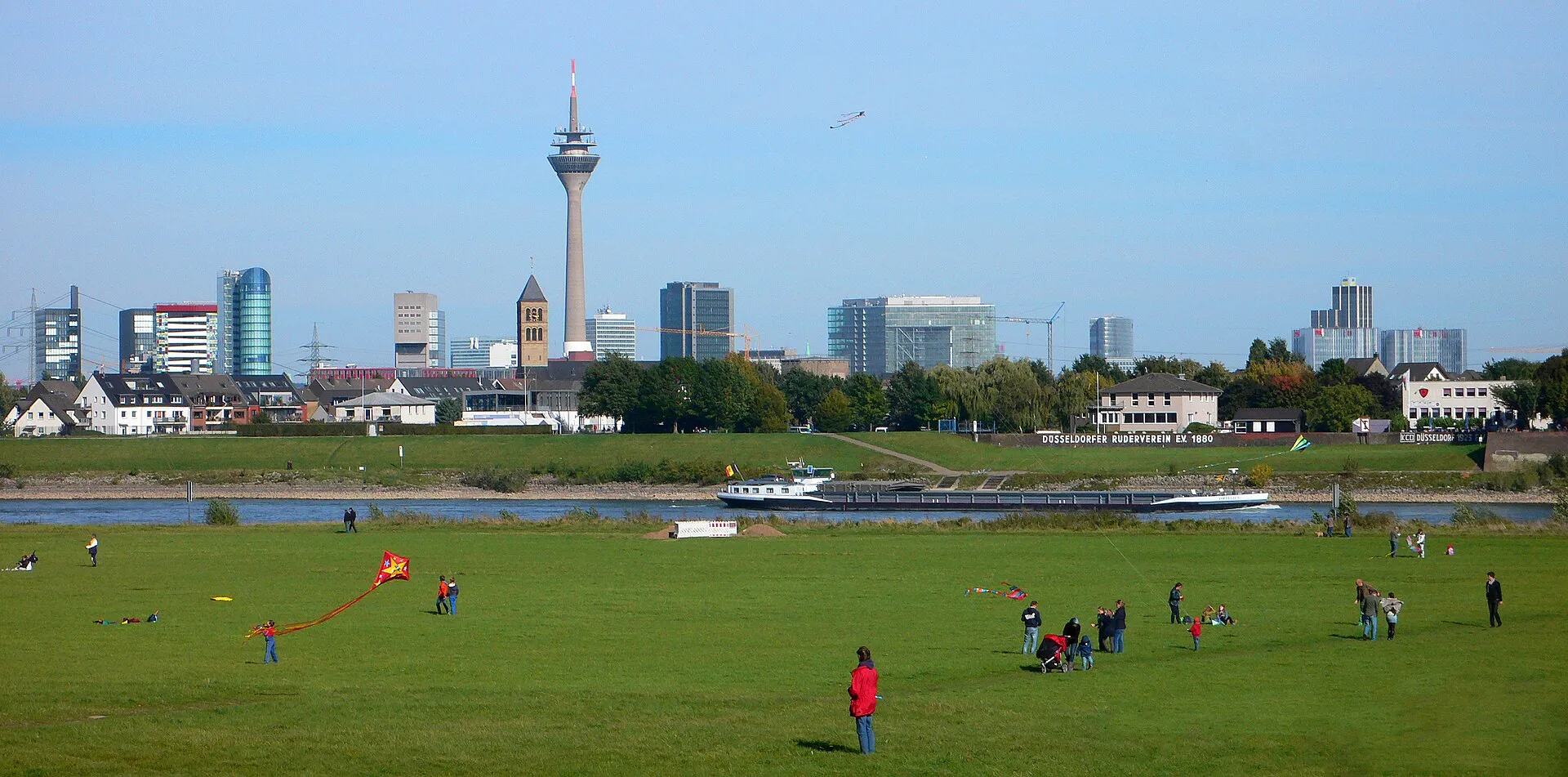 Düsseldorf skyline with Rheinturm tower and River Rhine, viewed from the opposite bank