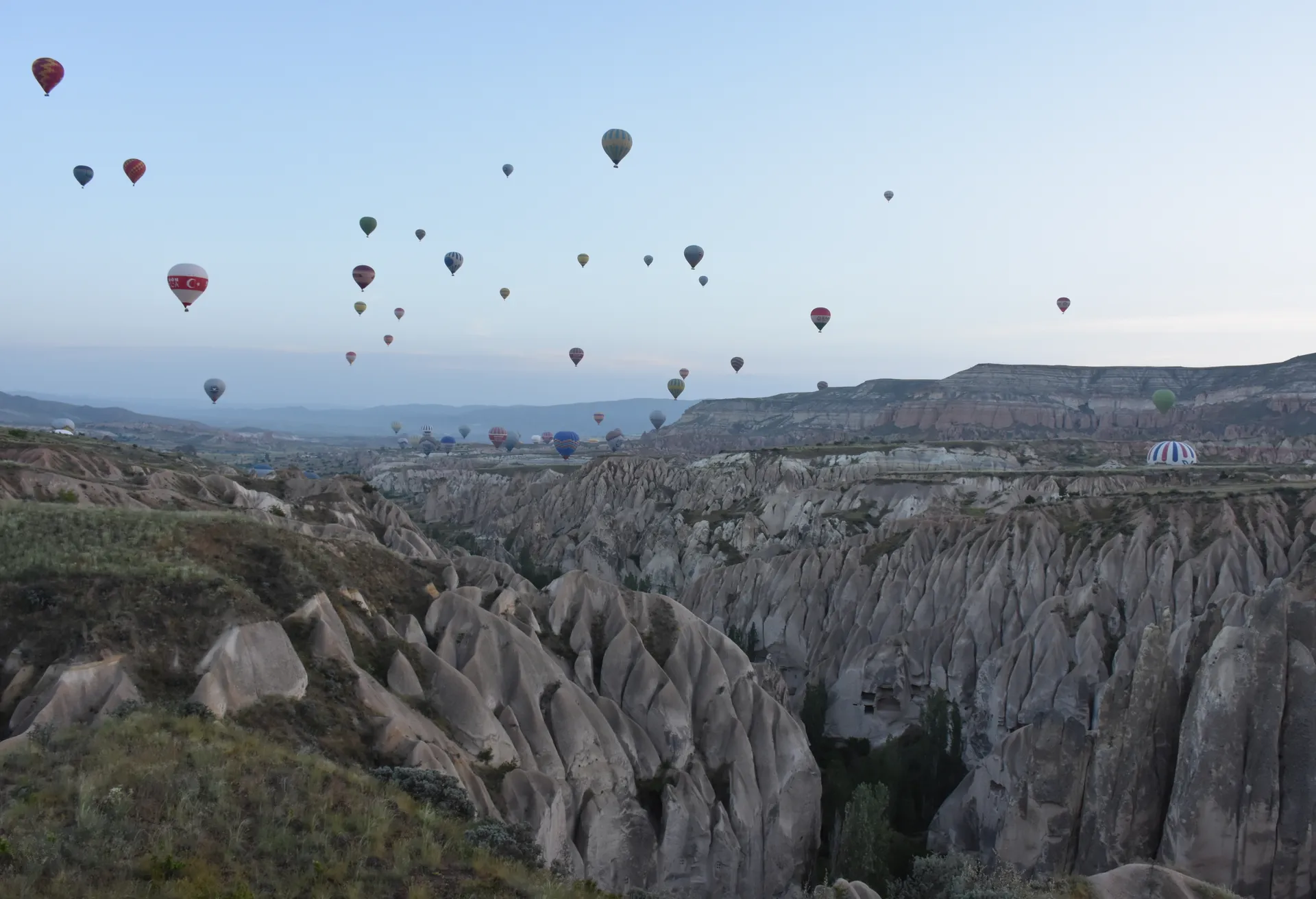 Hot-air balloons over the fairy chimneys of Cappadocia near Goreme, Turkey