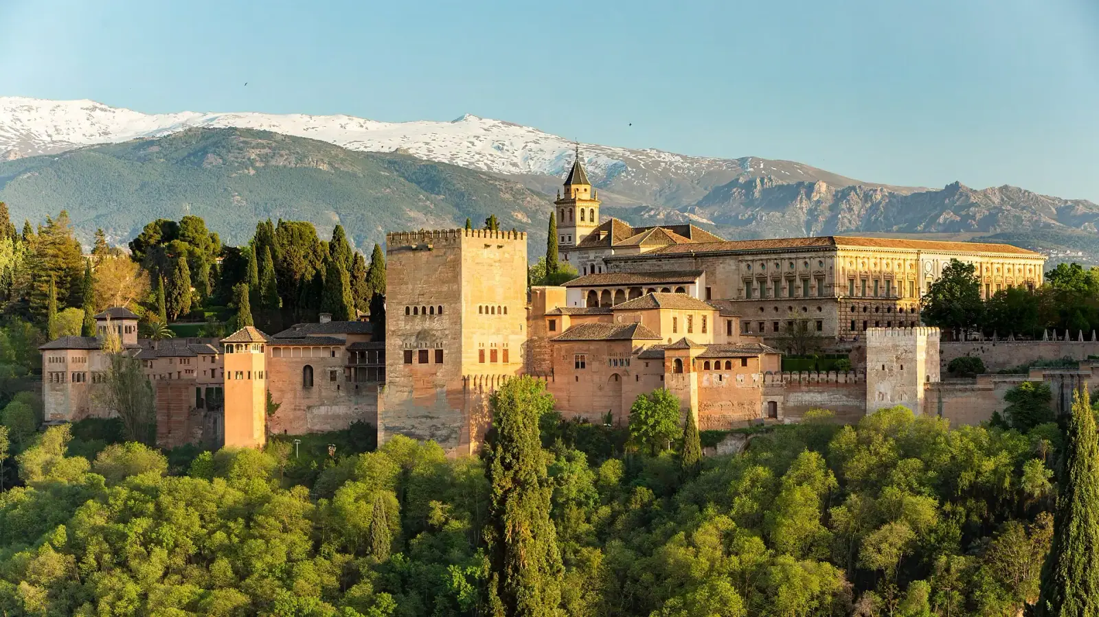 Alhambra palace complex with Sierra Nevada mountains behind, Granada, Spain