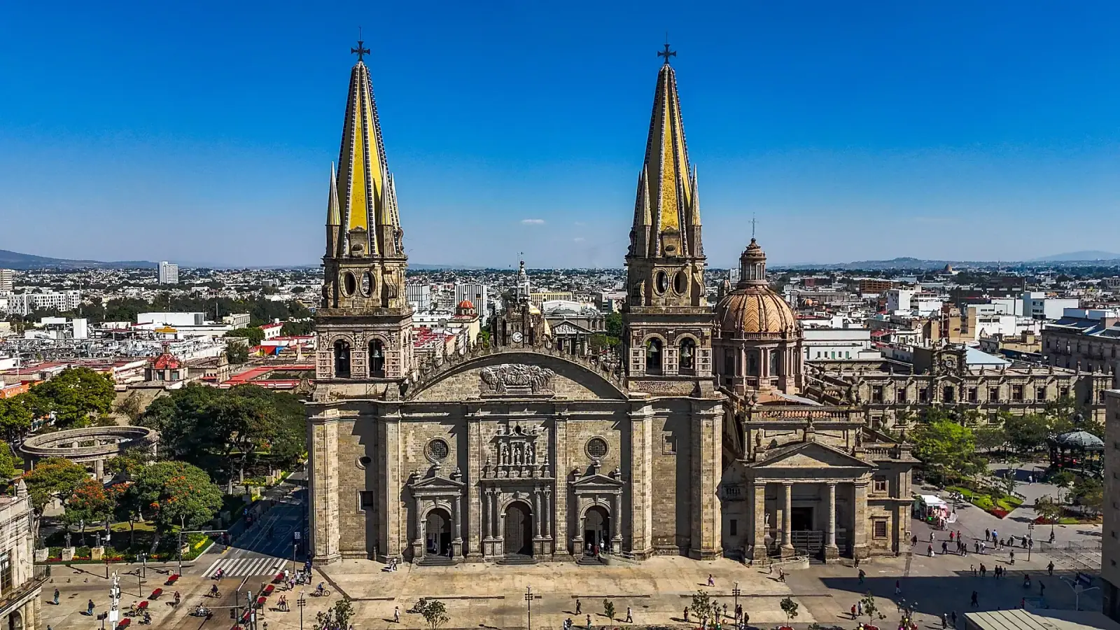 Aerial view of Guadalajara Cathedral with twin golden spires and city skyline