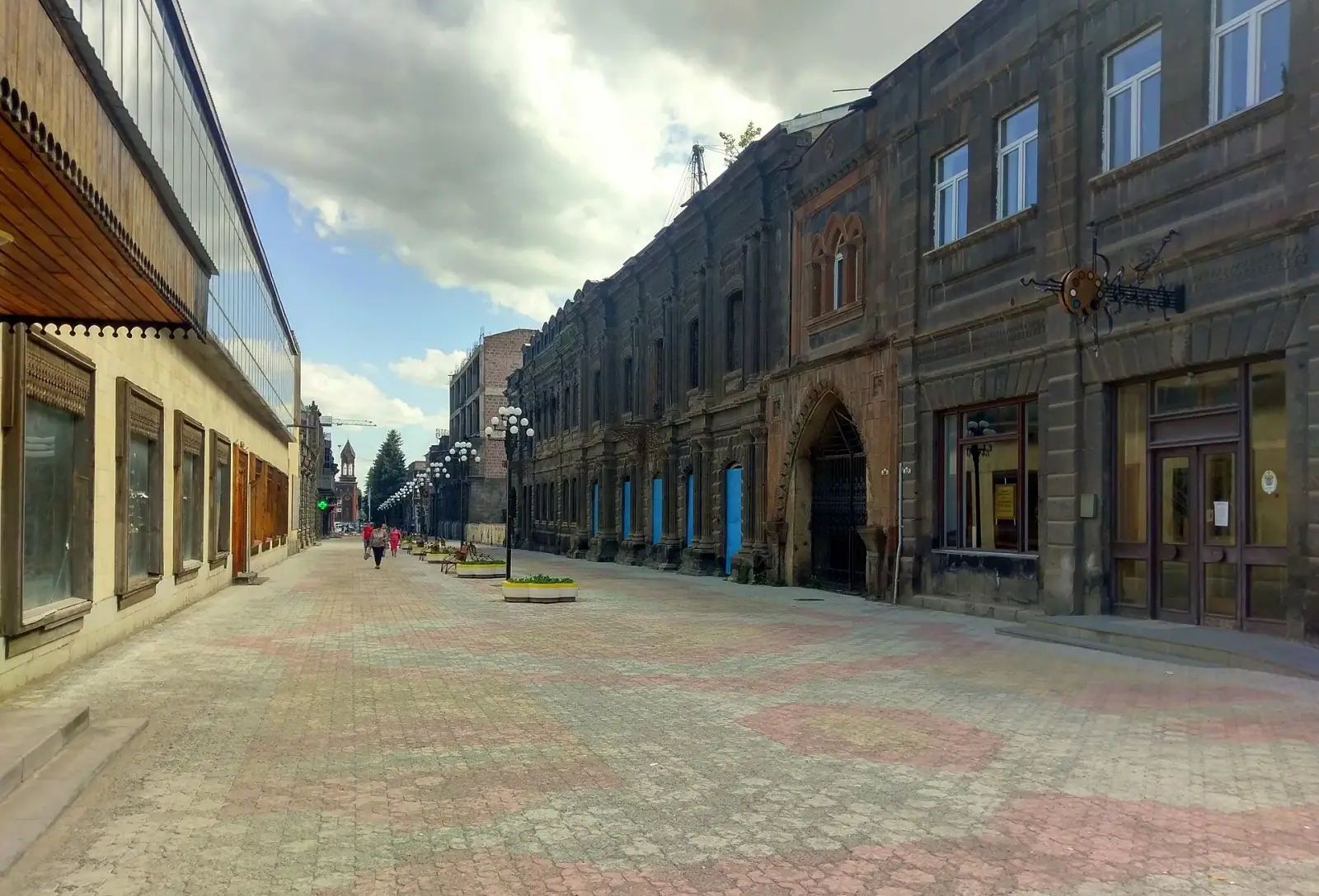 Abovyan Avenue pedestrian street lined with historic black tuff stone buildings in Gyumri's Kumayri district