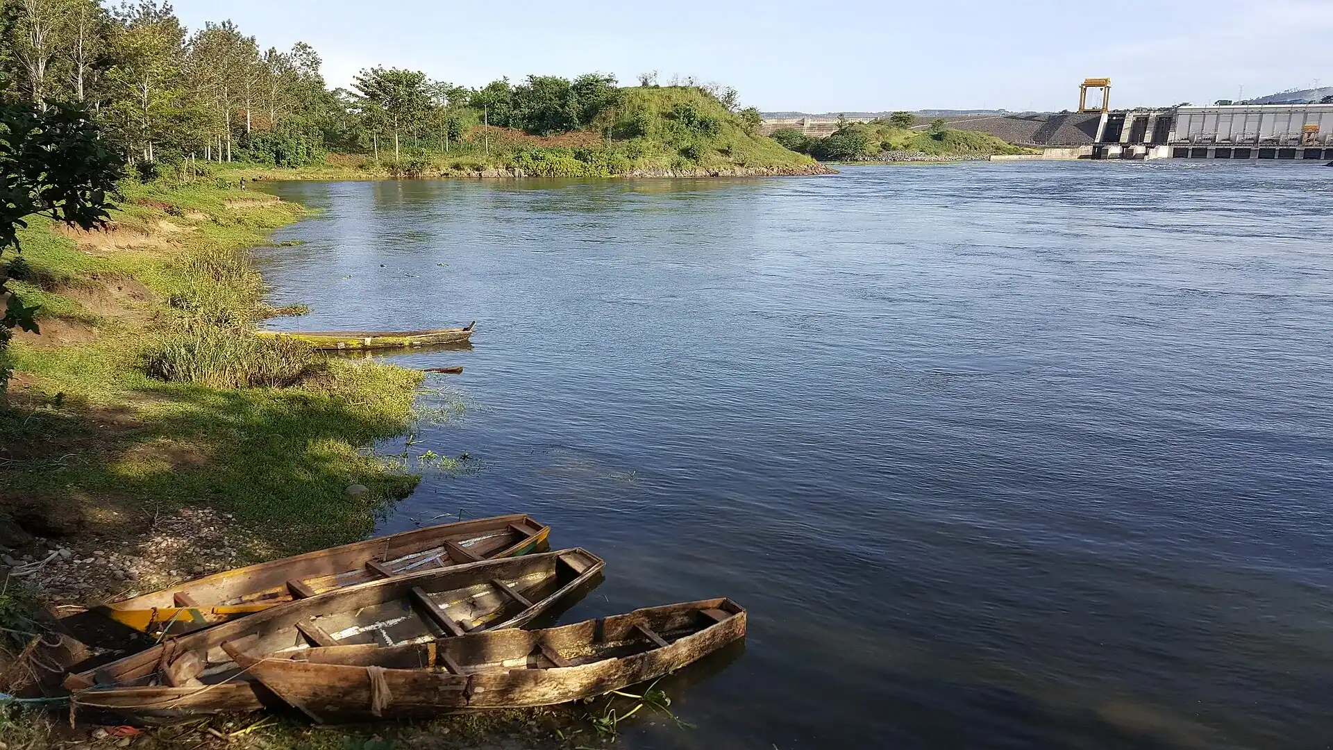 The Nile at Jinja with wooden boats on the bank