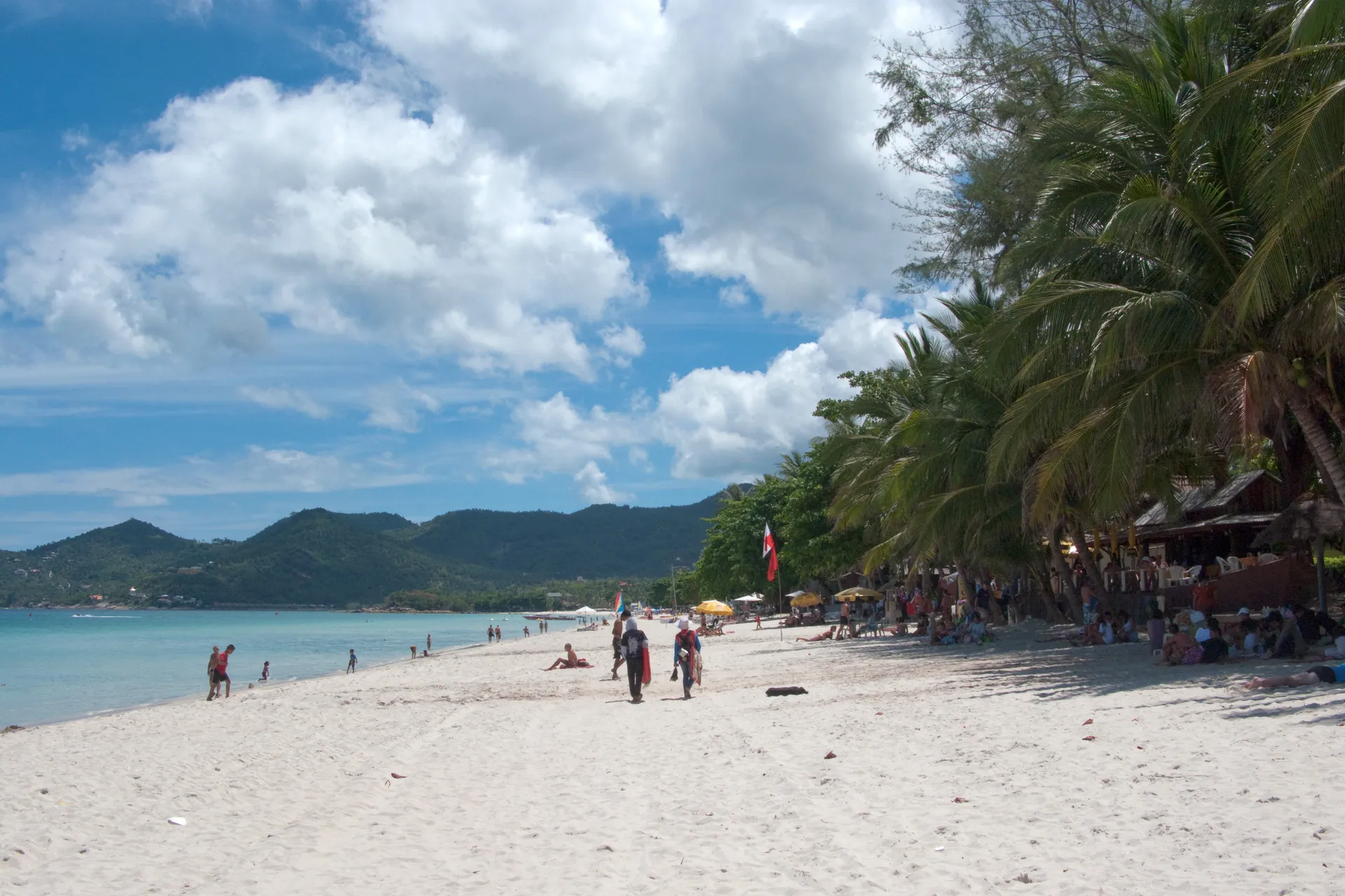 Chaweng Beach with white sand, palm trees, turquoise water and jungle hills, Koh Samui, Thailand