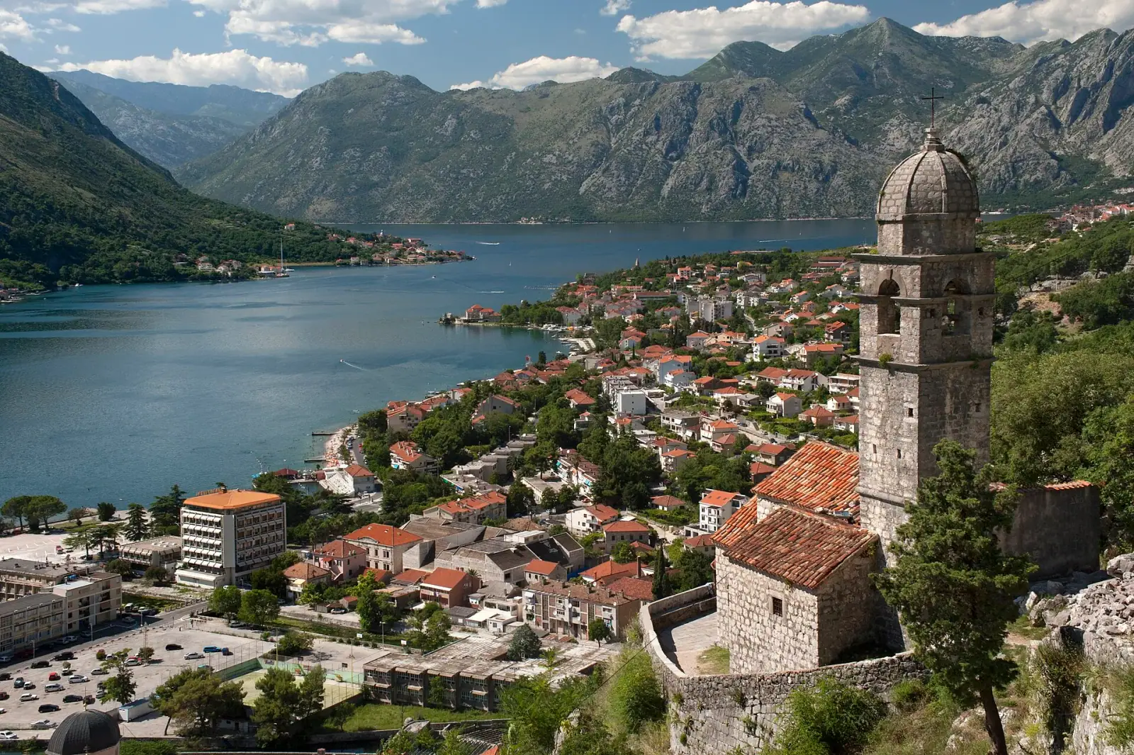 Church of Our Lady of Health perched on the ancient city walls above Kotor old town, with the Bay of Kotor and mountains beyond