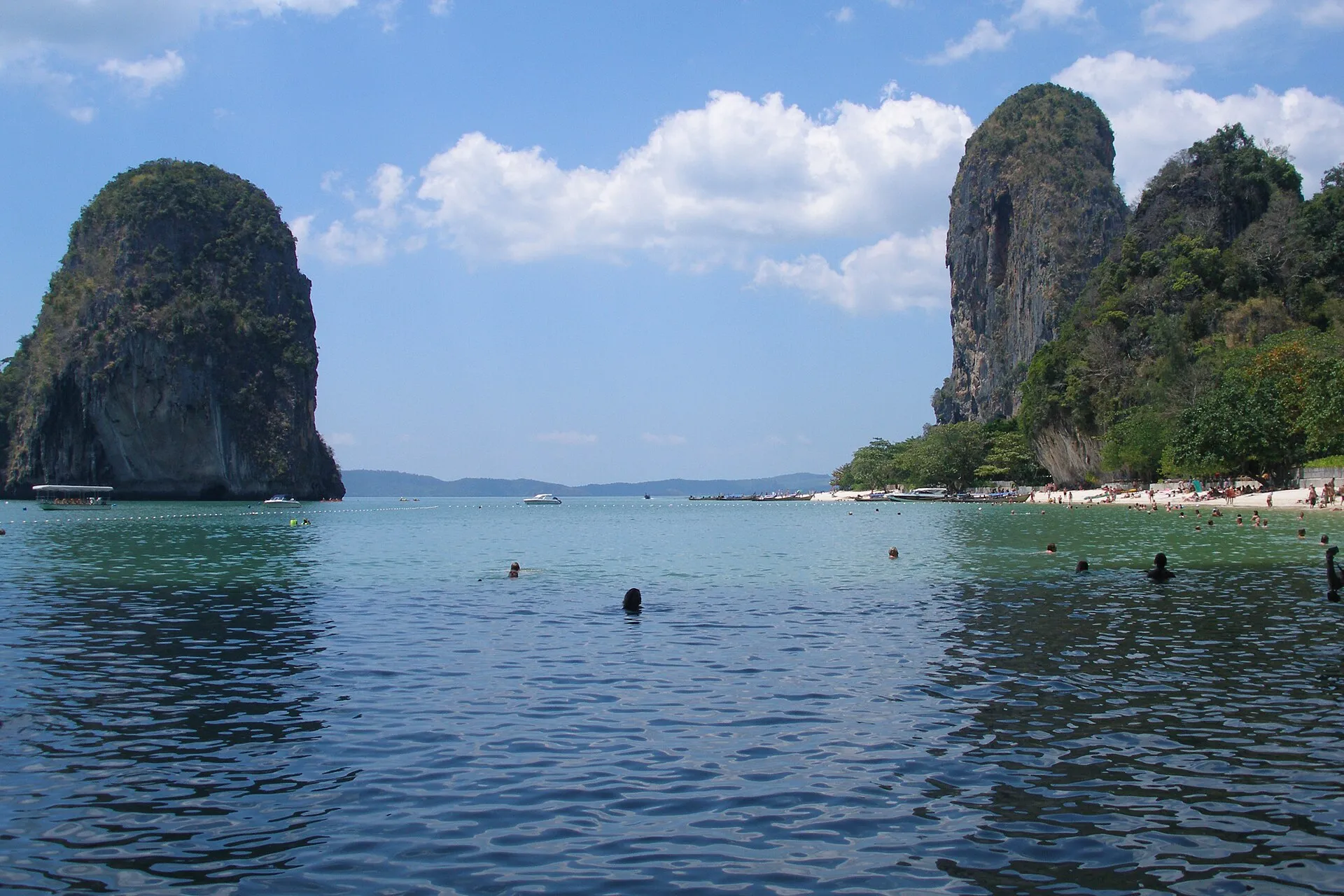 Turquoise bay at Railay Beach flanked by towering limestone karst cliffs, Krabi, Thailand