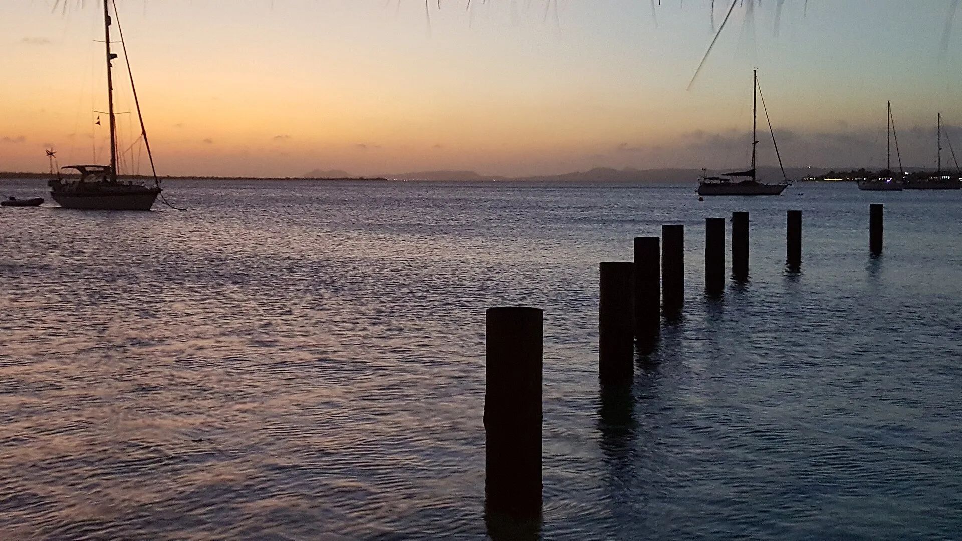 Sailing boats off Kralendijk at sunset