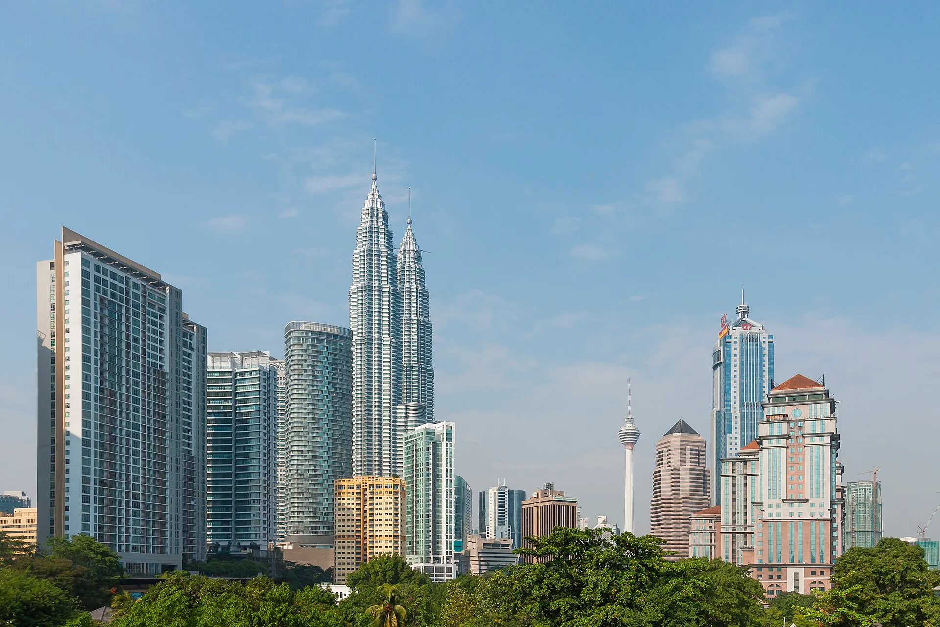 Kuala Lumpur skyline with Petronas Twin Towers and KL Tower under blue sky