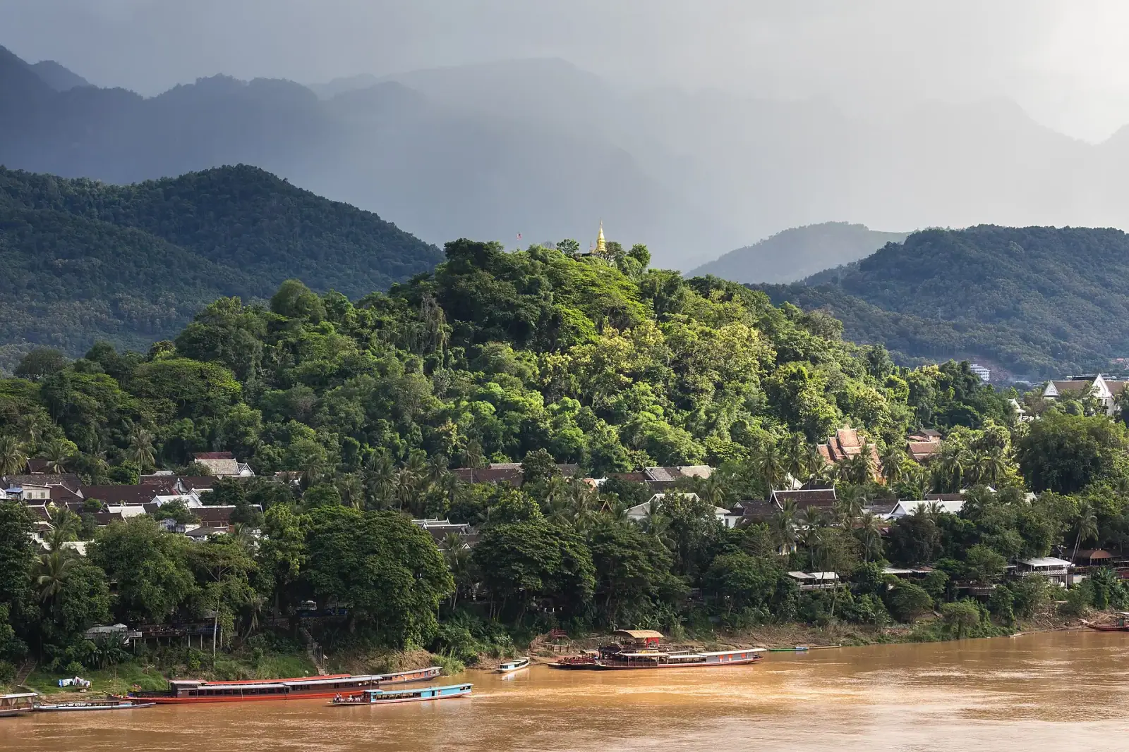 Mount Phou Si with golden stupa rising above Luang Prabang and the Mekong River