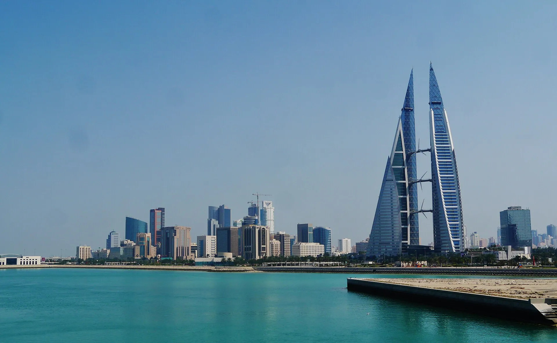 Manama skyline with Bahrain World Trade Center across turquoise bay waters