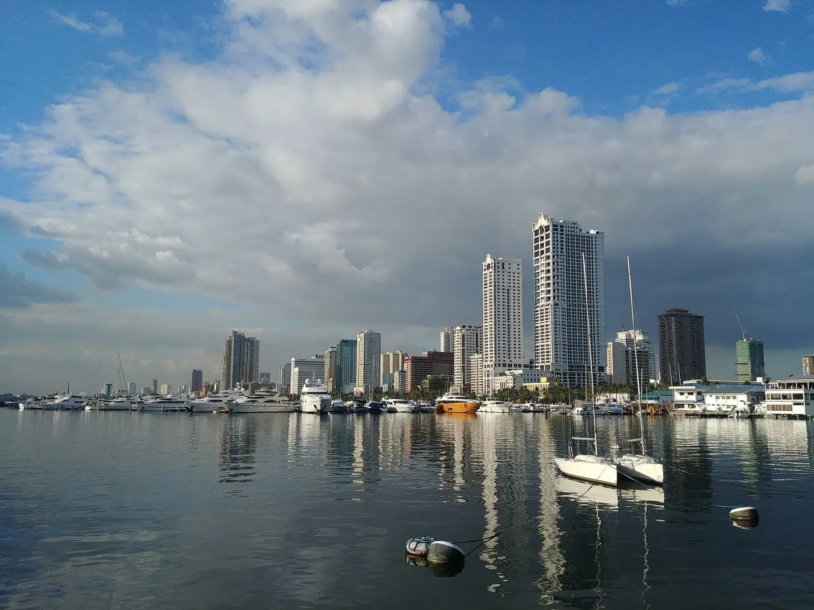 Manila skyline viewed from Harbor Square with yachts in the foreground