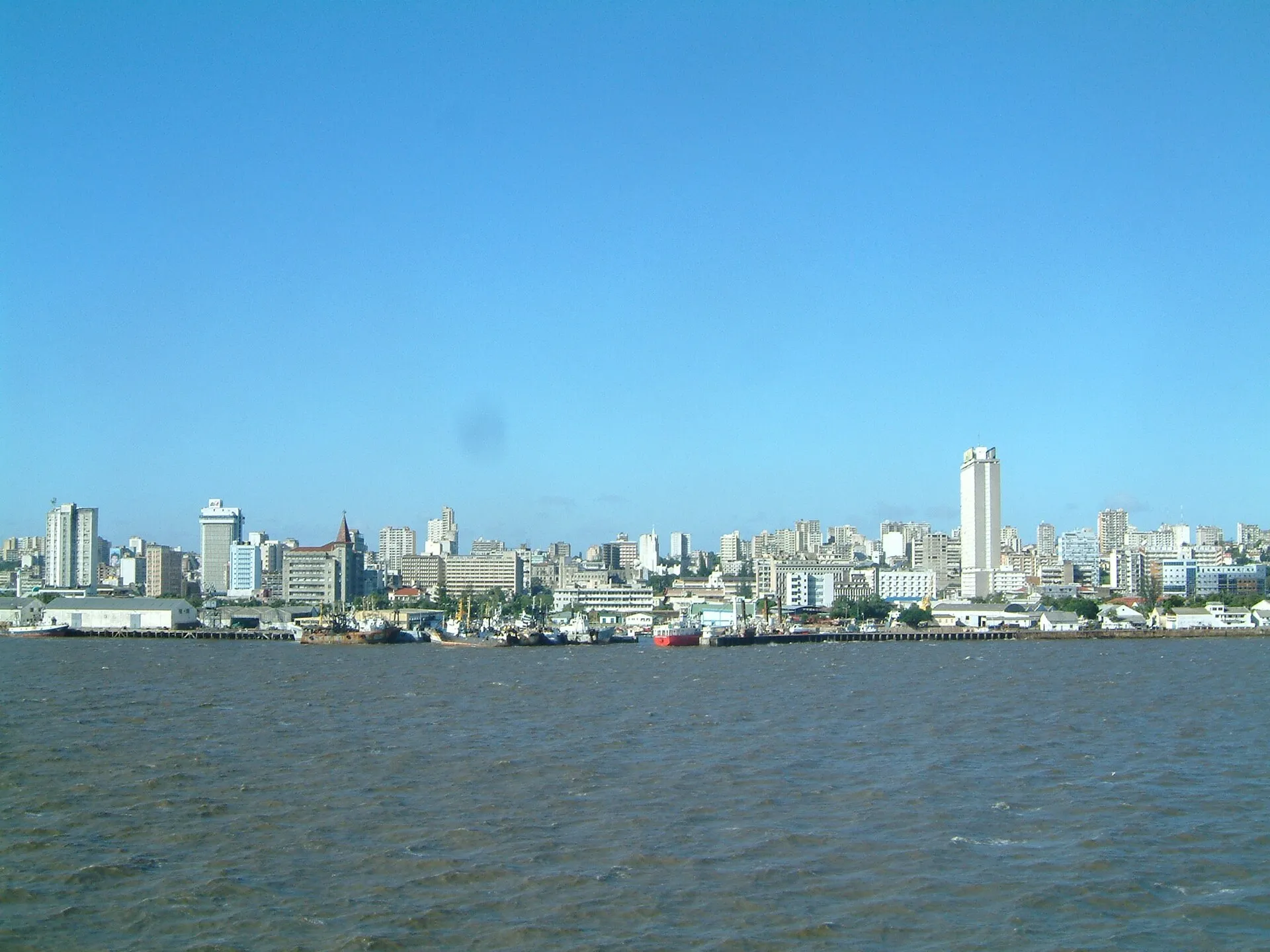 Maputo city skyline seen from the bay, with port and distinctive skyline buildings under clear blue sky