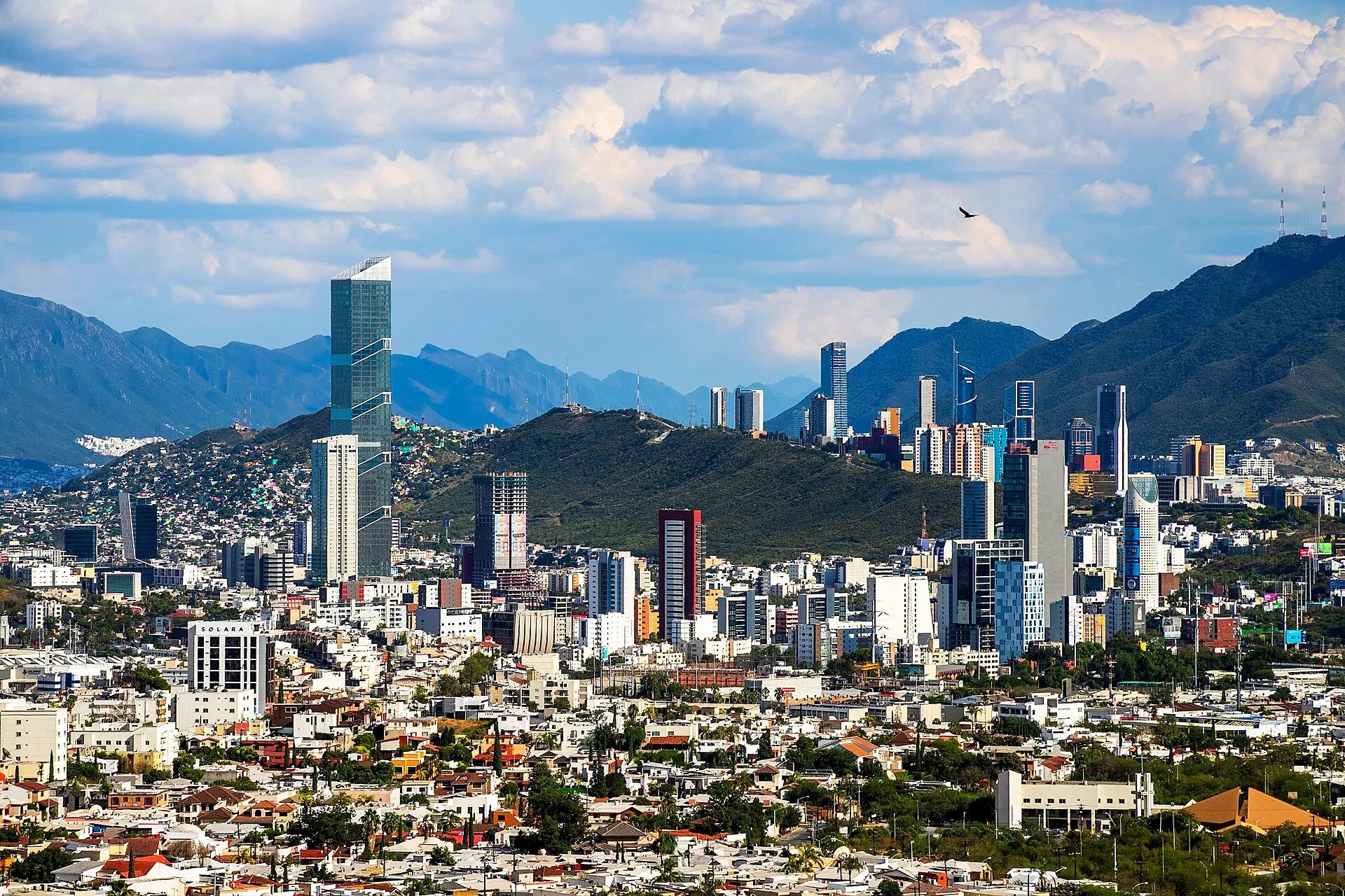 The high rise skyline of Monterrey, Mexico standing in front of the rugged Sierra Madre mountains on a bright day