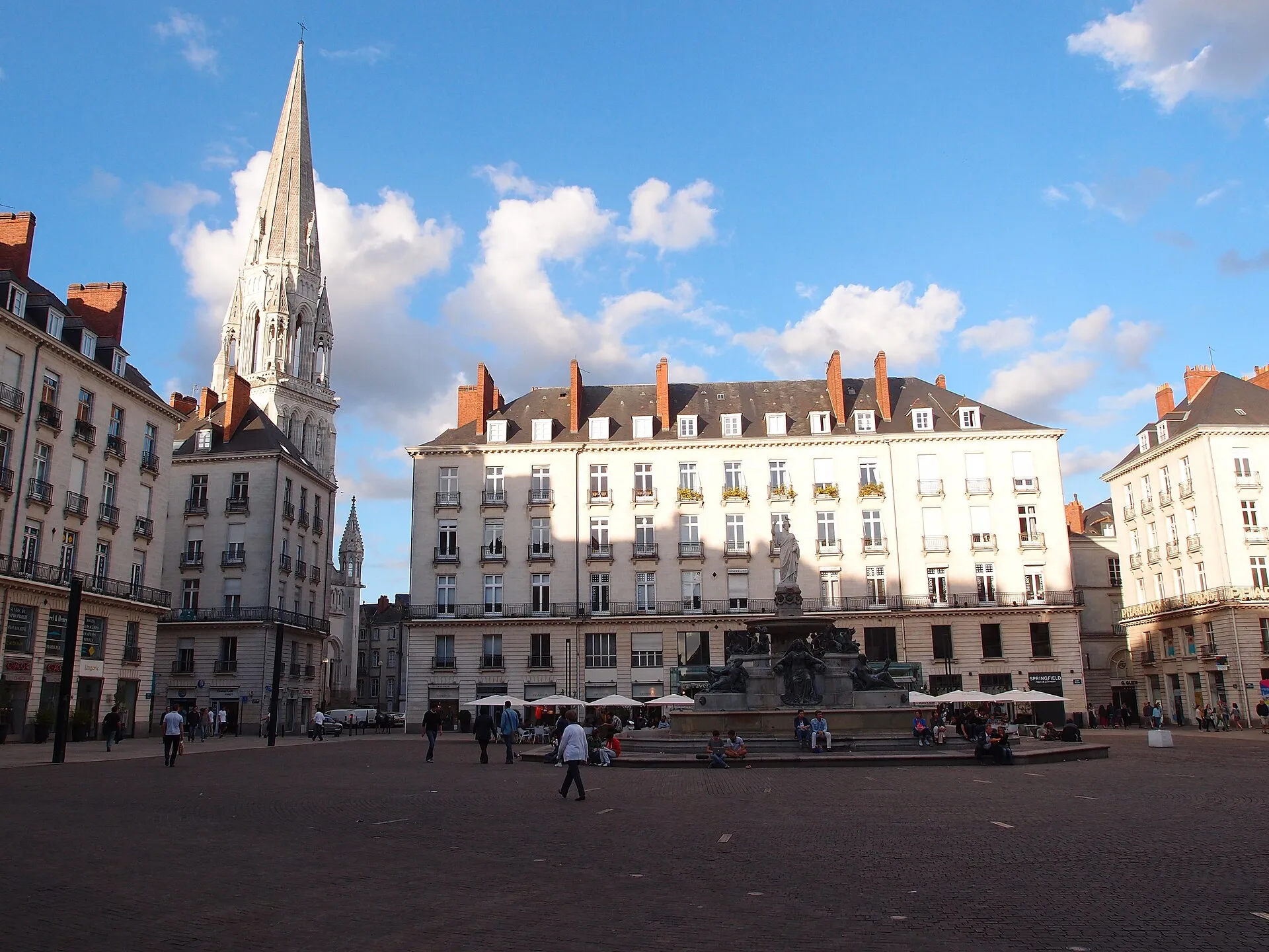 Place Royale in Nantes with fountain and church spire on a sunny day
