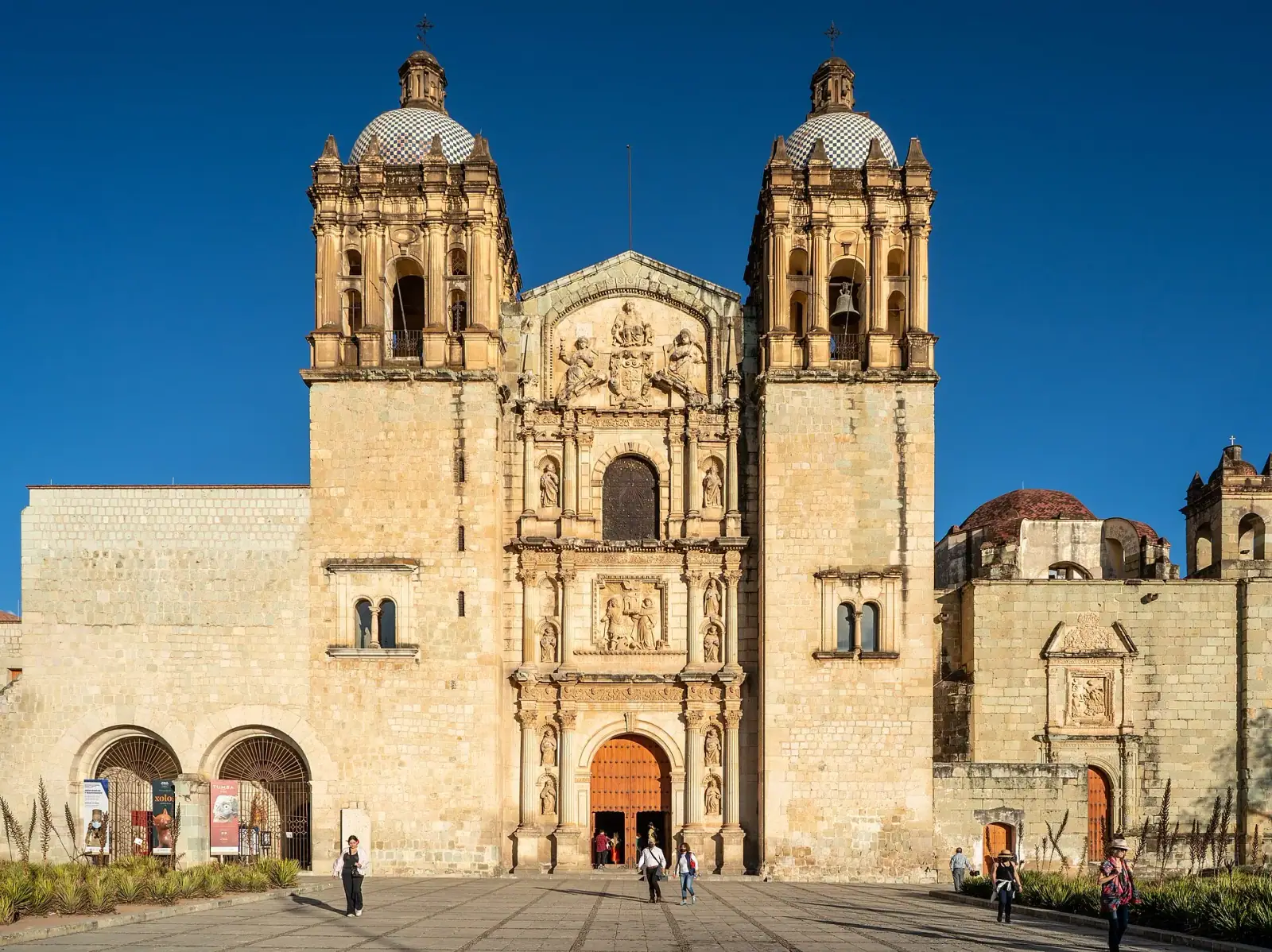 Facade of Santo Domingo de Guzman church in Oaxaca City under deep blue sky