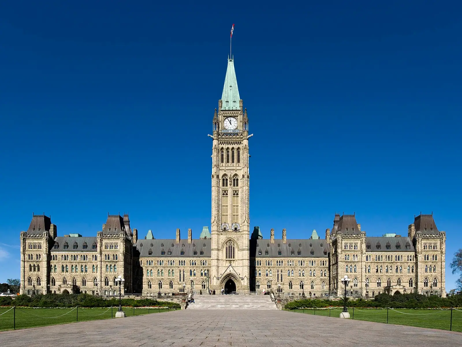 Parliament Hill Centre Block with Peace Tower under bright blue sky, Ottawa, Canada