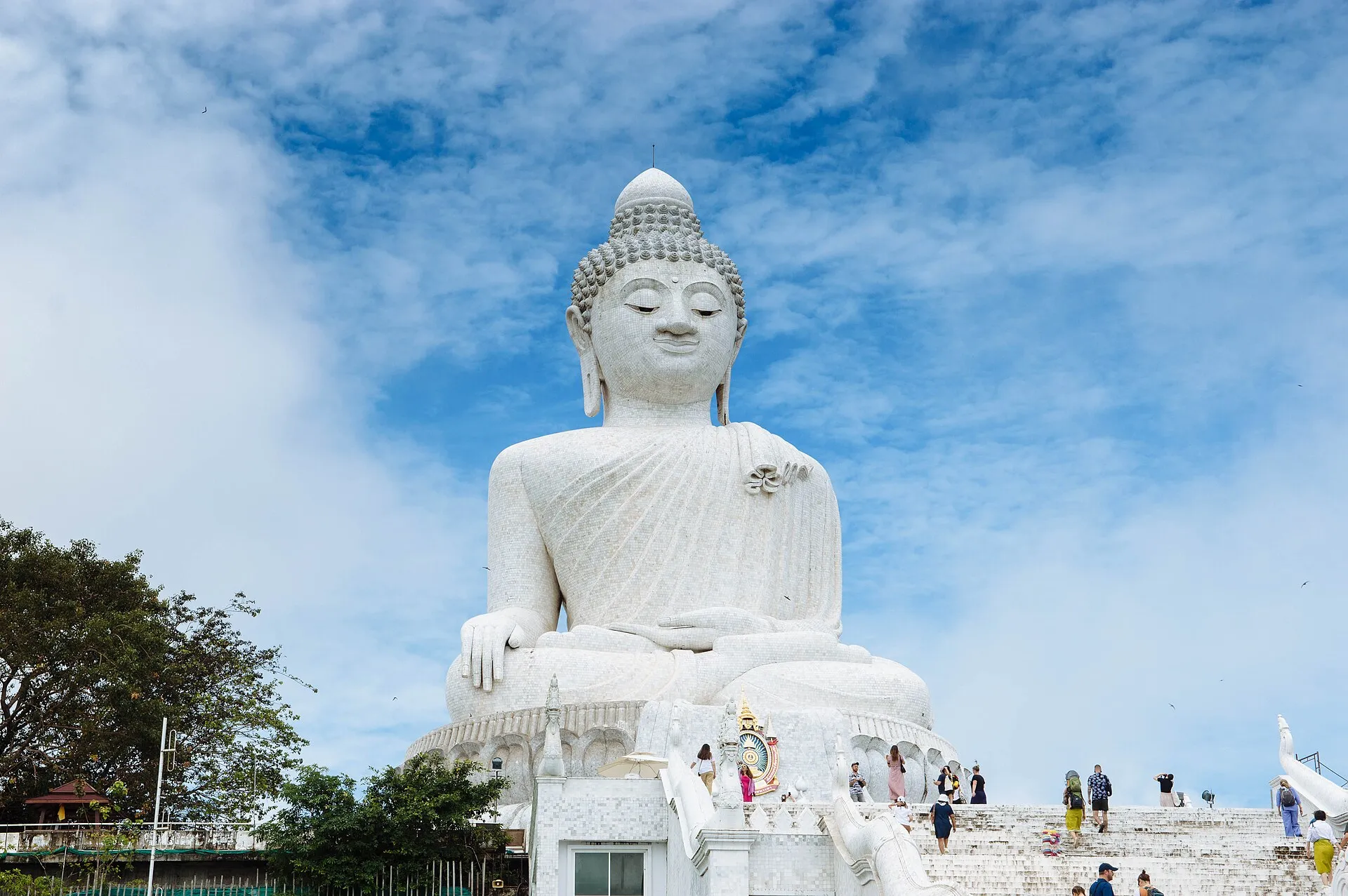 The Big Buddha of Phuket, a white marble seated Buddha statue on Nakkerd Hill against a blue sky