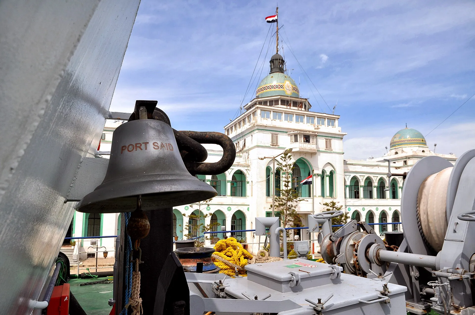 The Suez Canal Authority building at Port Said, past a ship bell marked Port Said