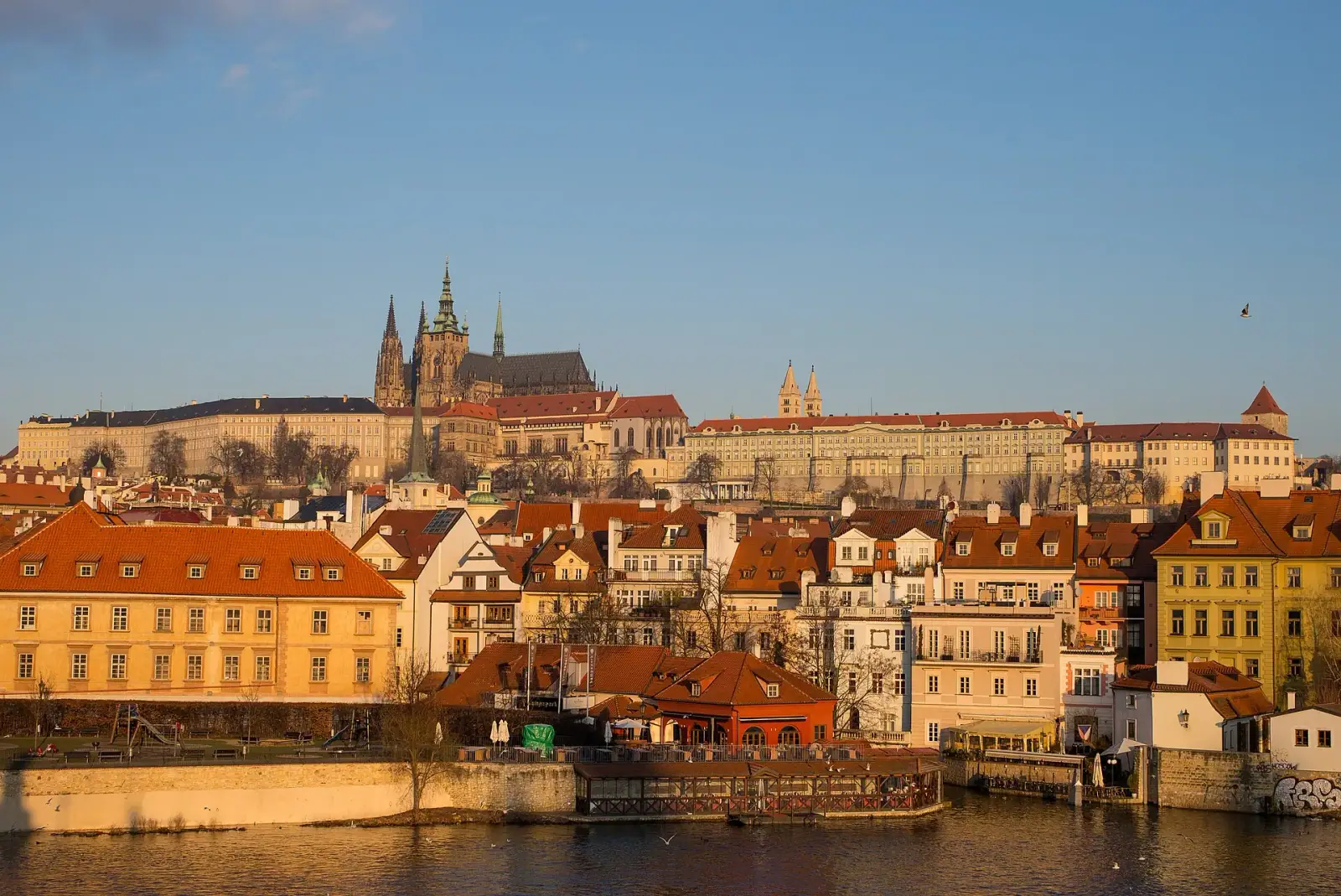 Prague Castle and St. Vitus Cathedral above the Vltava River at dawn