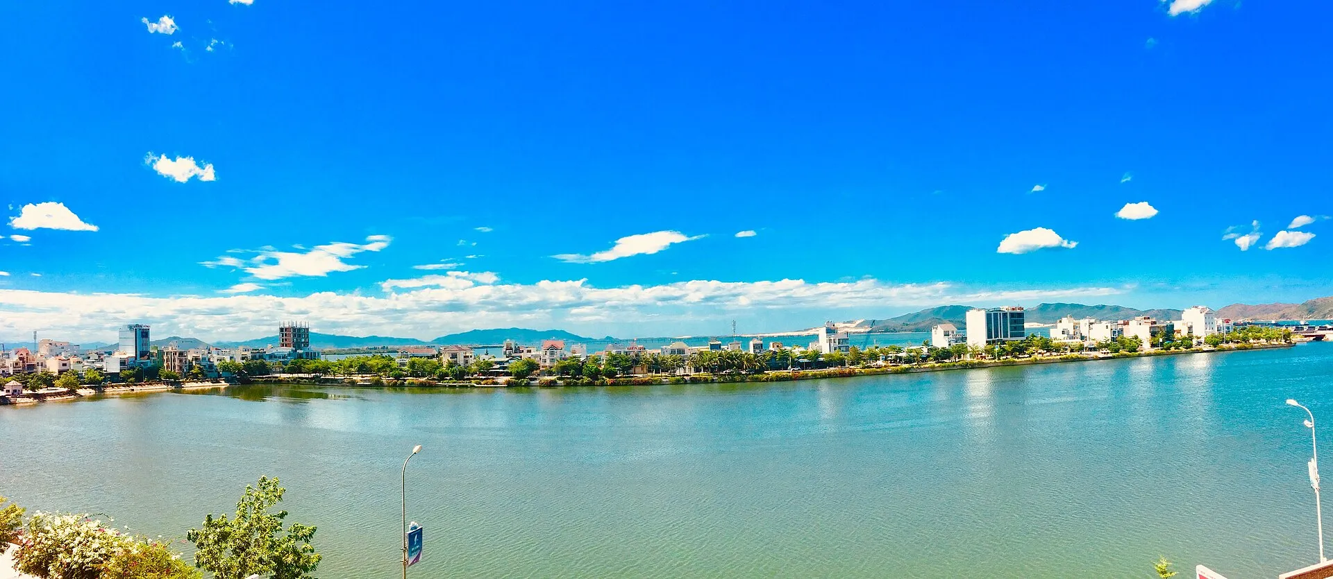 Quy Nhon city skyline across the lagoon with mountains in the background