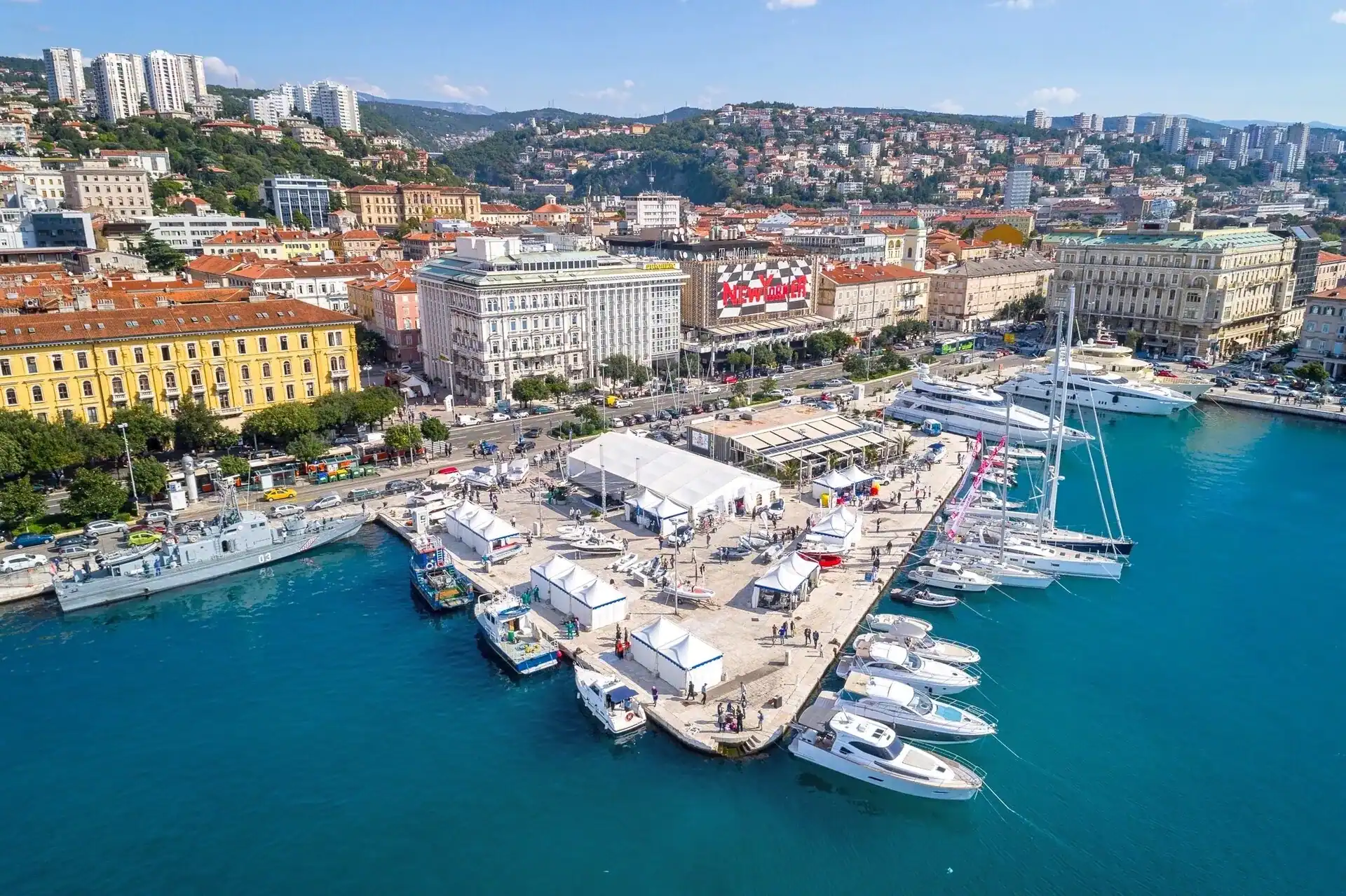 Boats moored along the Rijeka waterfront with the city rising behind