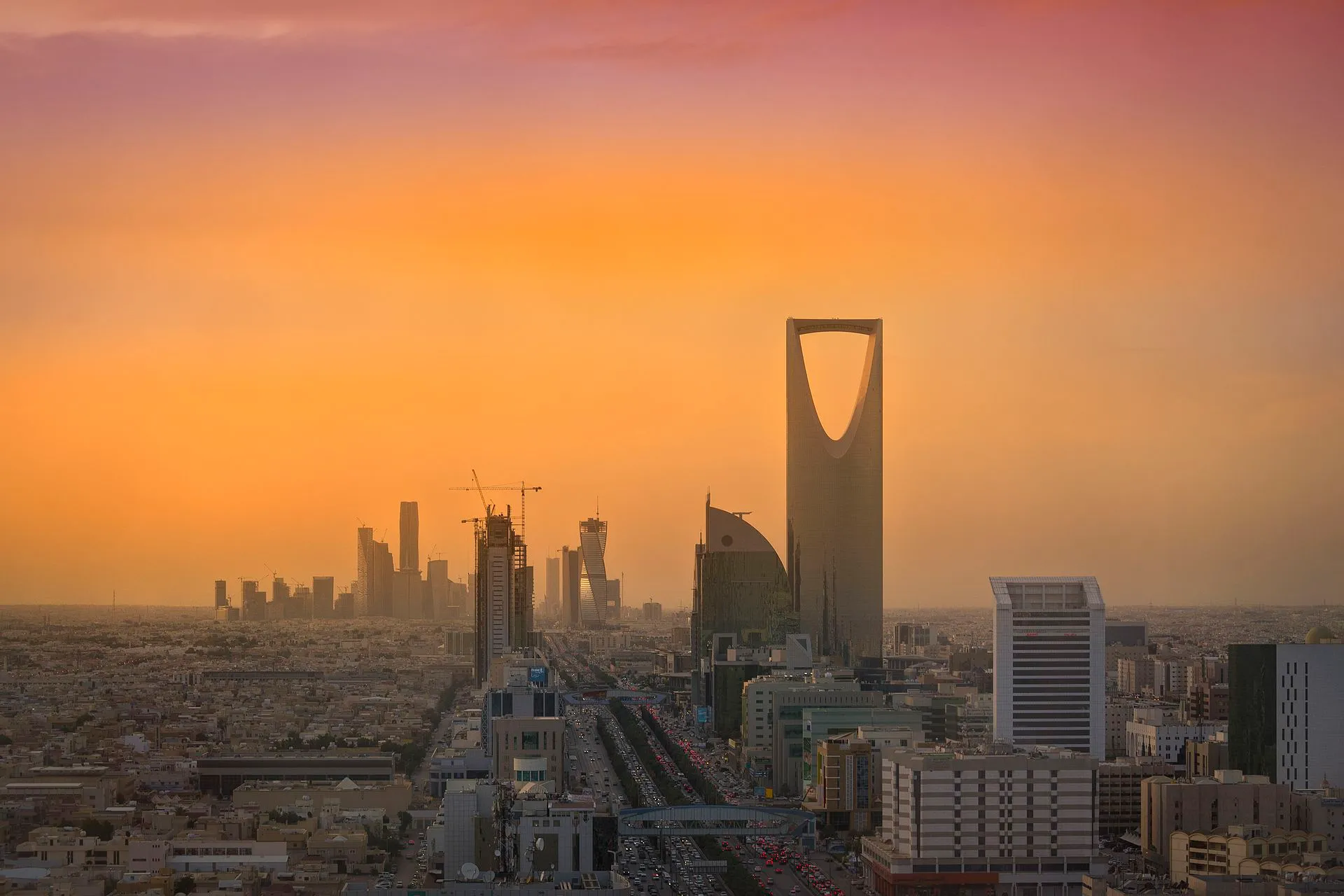 Riyadh skyline at golden hour showing Kingdom Centre Tower and KAFD financial district