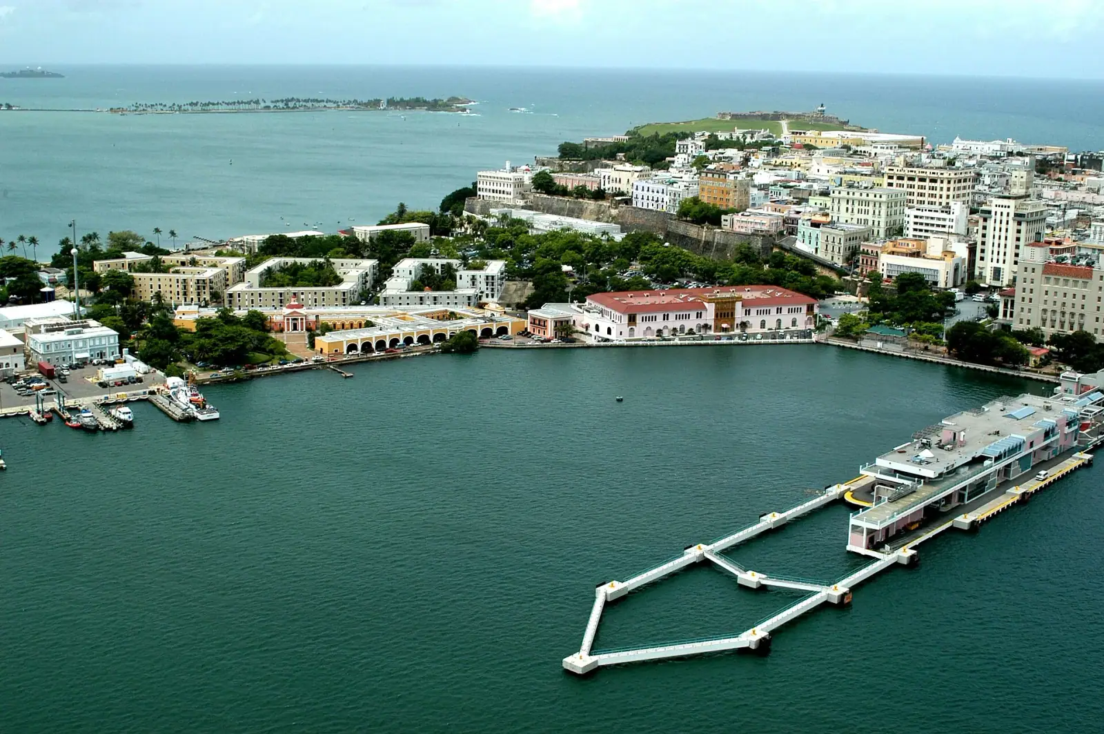 Aerial view of Old San Juan historic district with colorful colonial buildings, harbor, and El Morro fort