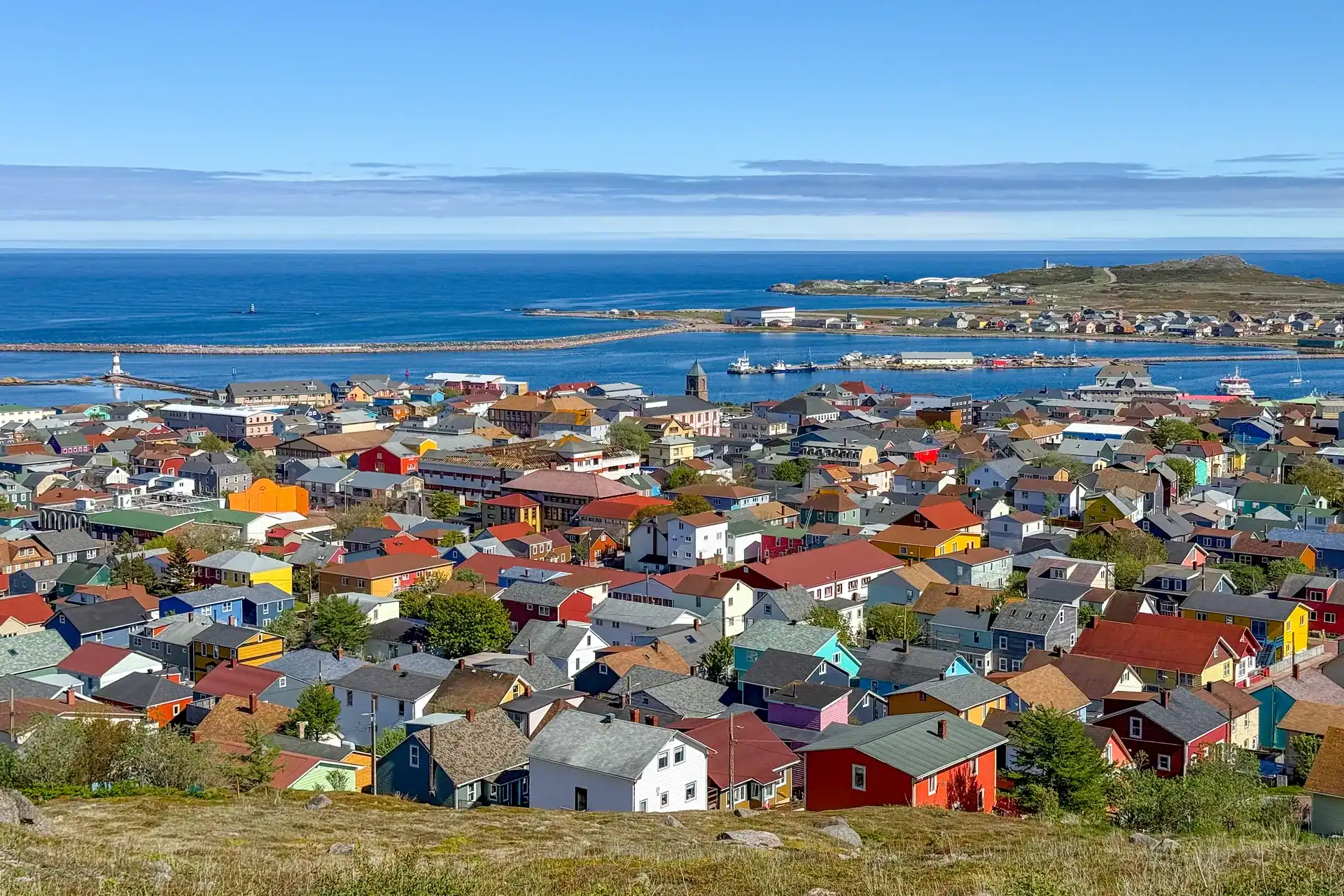 The painted houses of Saint-Pierre above its harbour