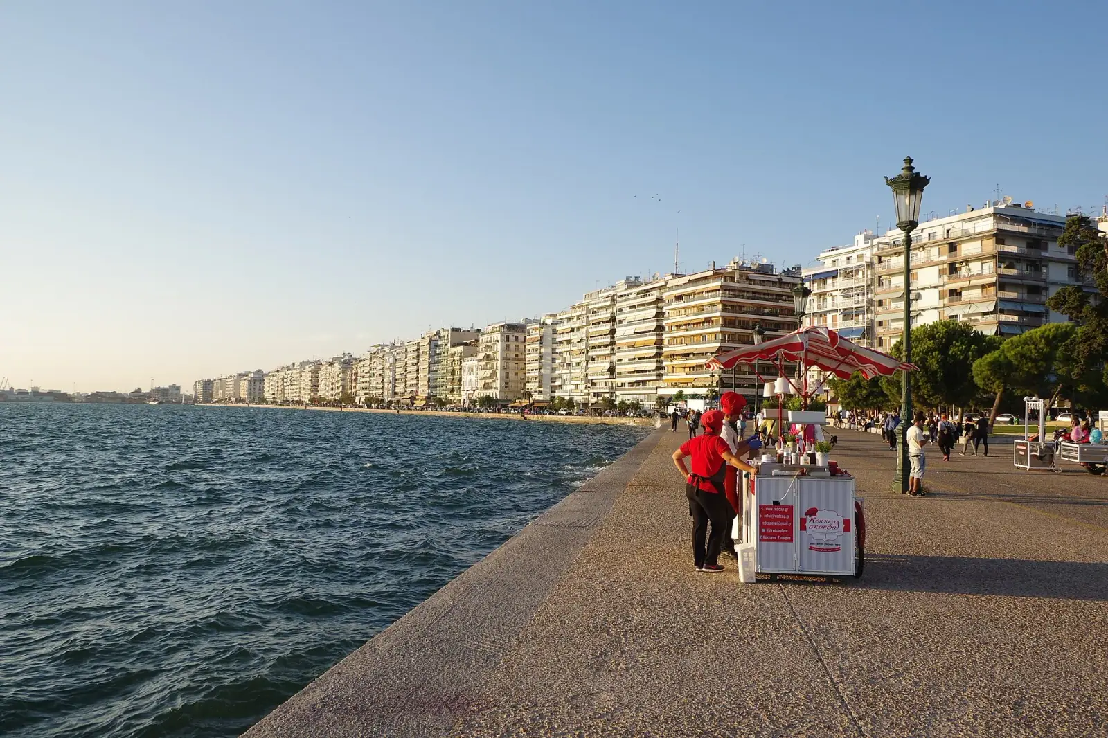 Thessaloniki seafront promenade at golden hour with the city skyline stretching along the bay
